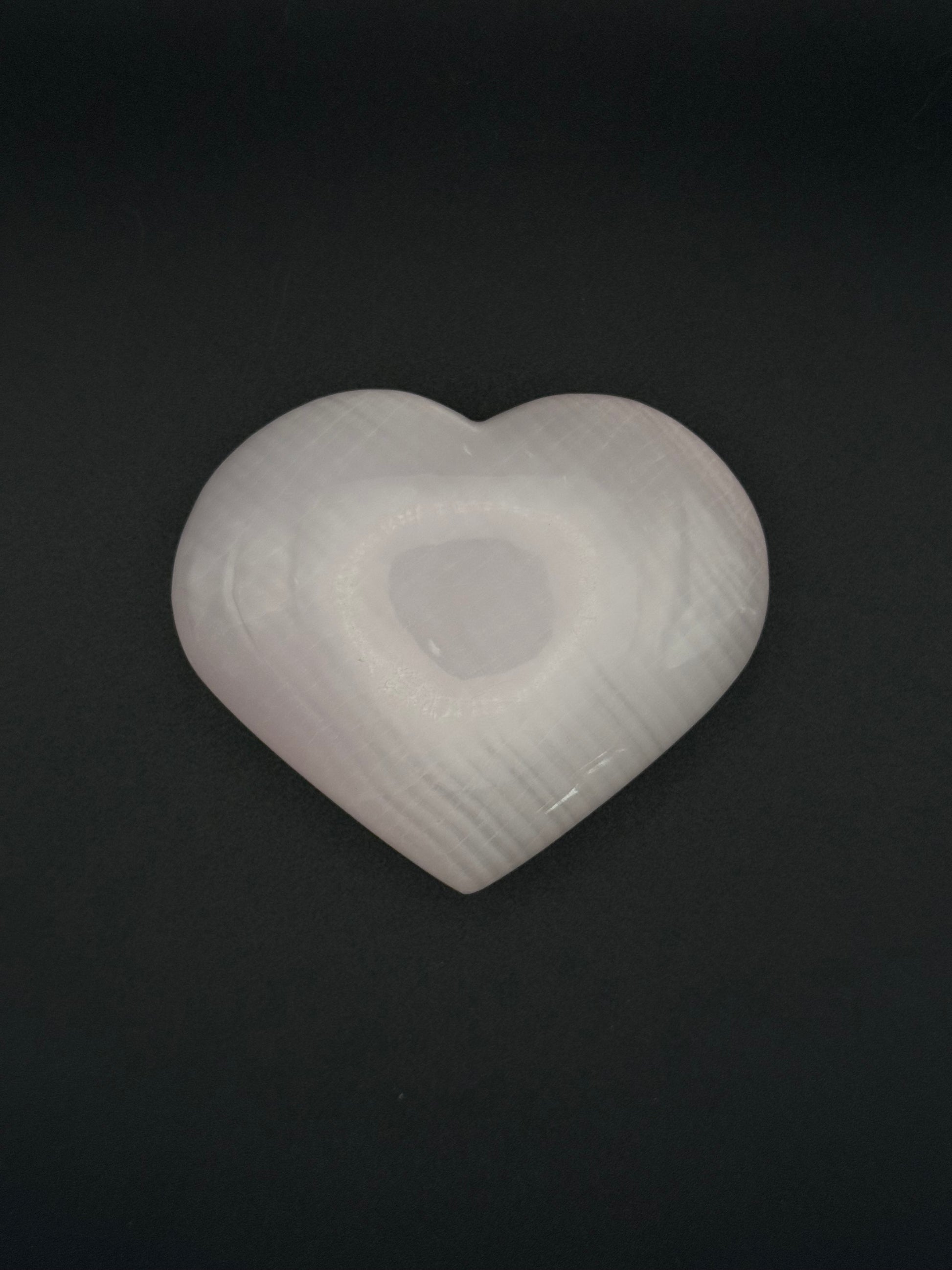 Polished pink calcite heart. Pink calcite glows under uv light.