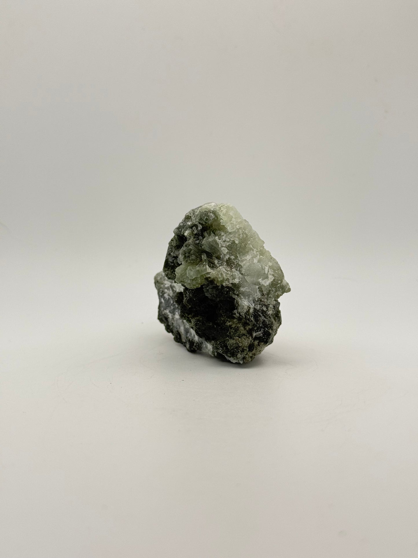 Raw Prehnite specimen with amazing green color.