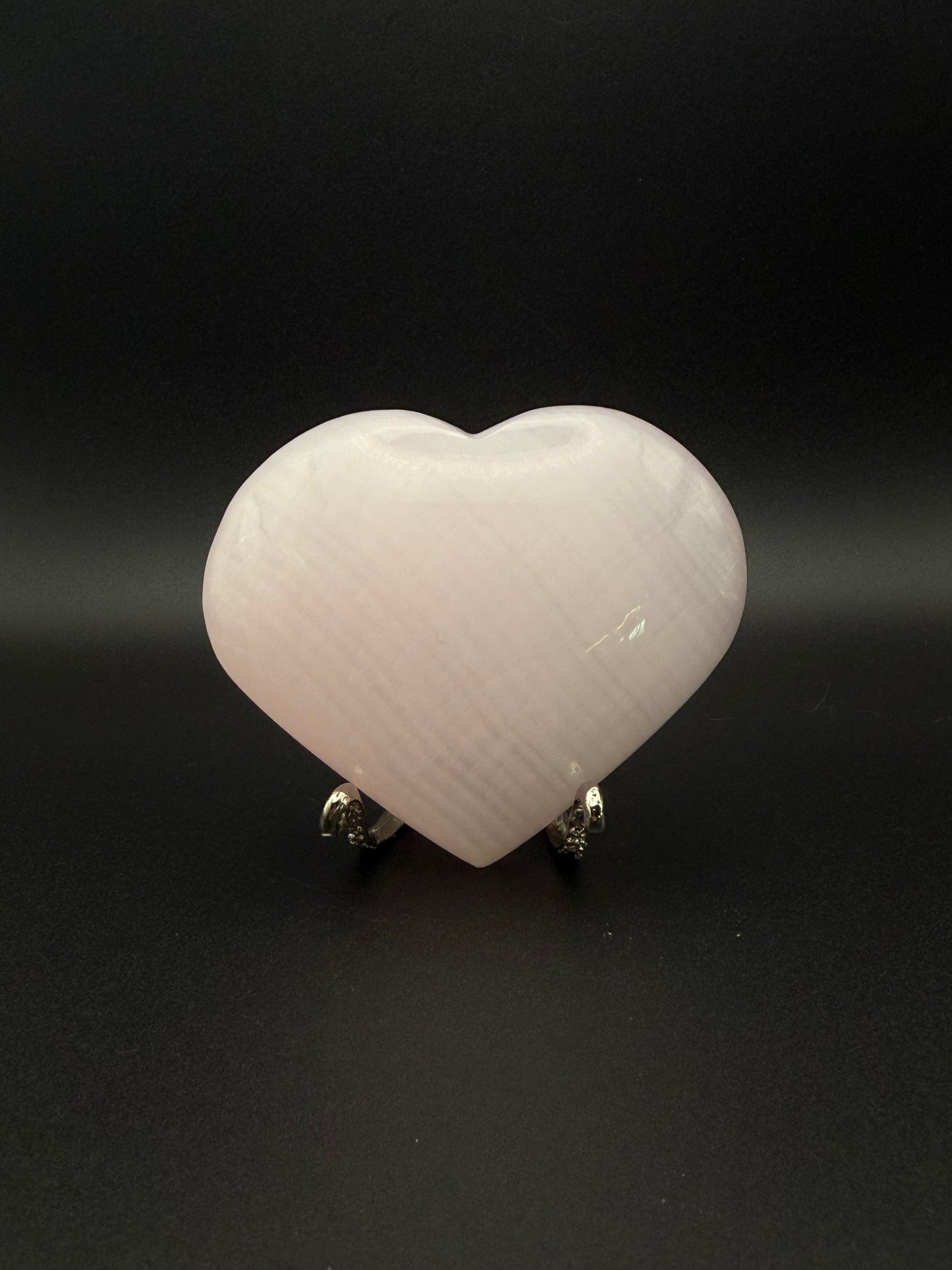 Polished pink calcite heart. Pink calcite glows under uv light.