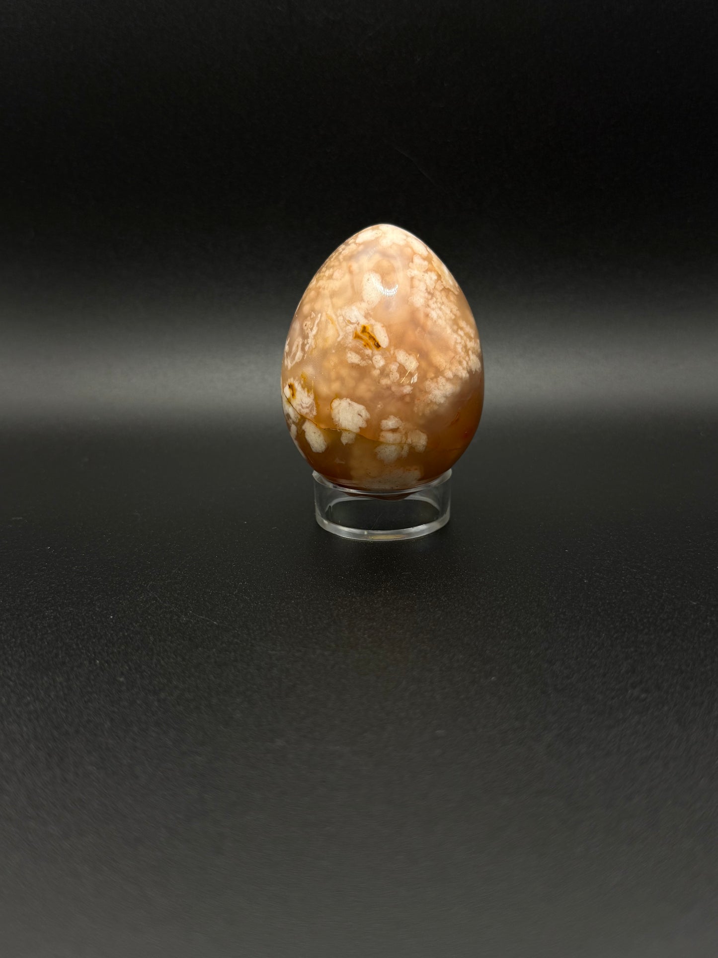 Flower Agate polished crystal in the shape of an egg.