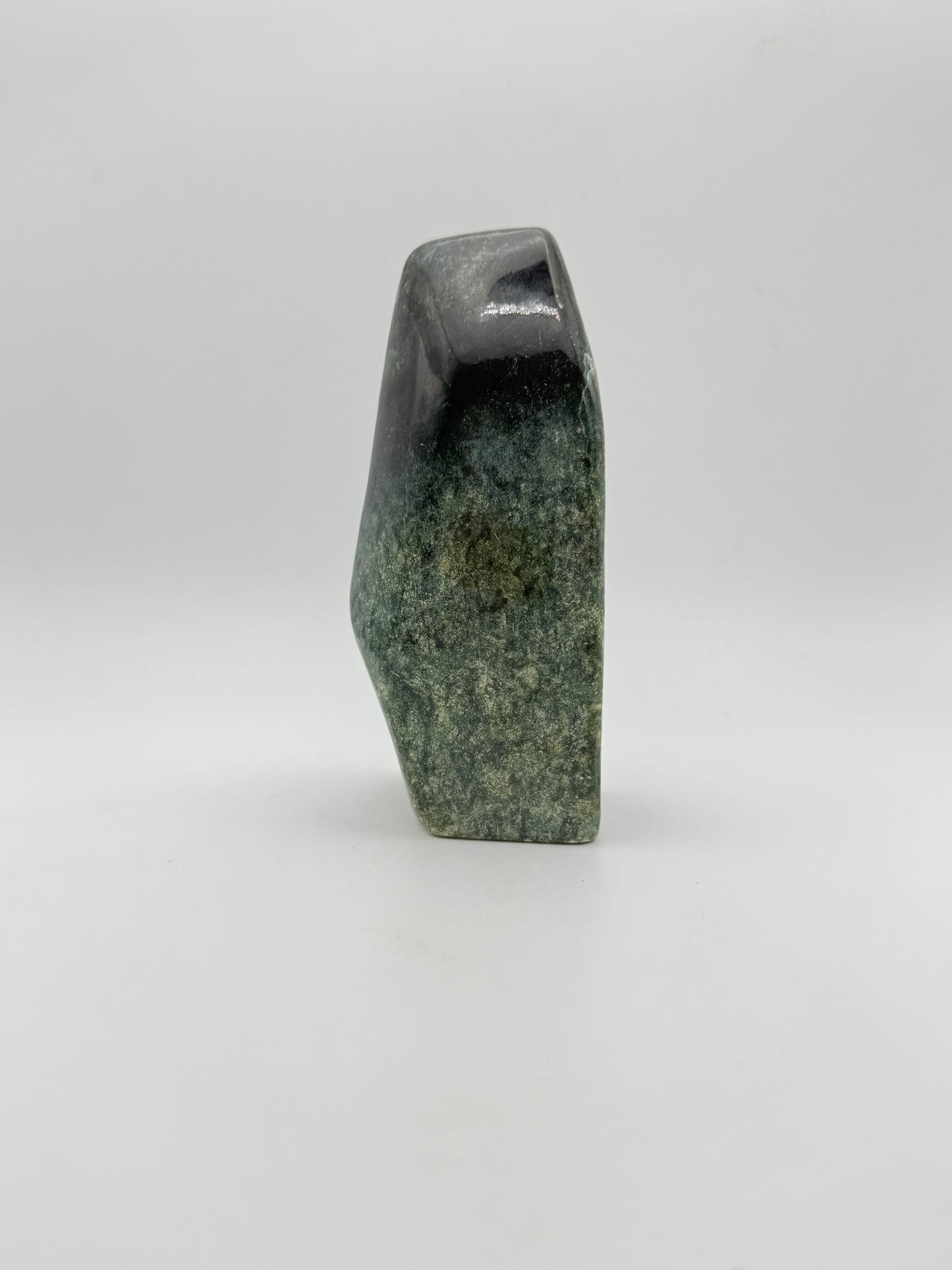 Polished green jade free form.