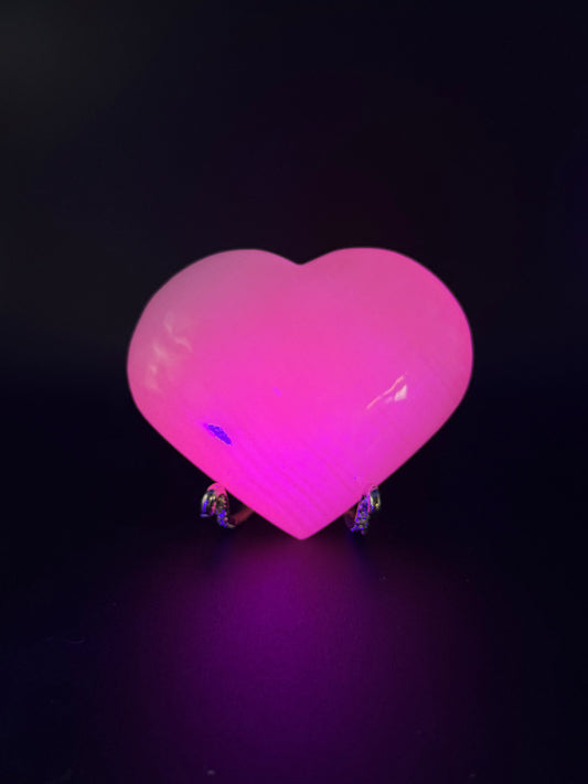 Polished pink calcite heart. Pink calcite glows under uv light.