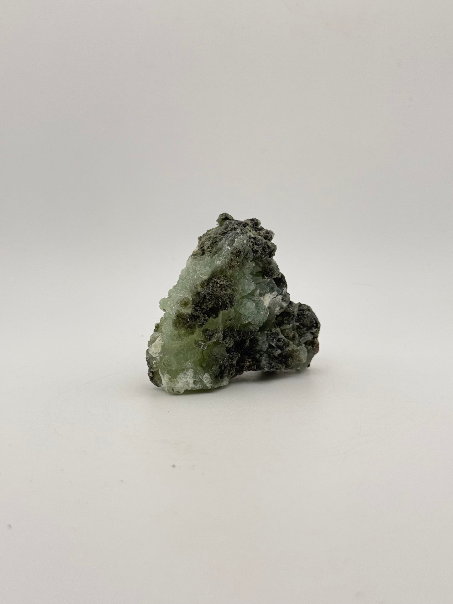 Raw Prehnite specimen with amazing green color.