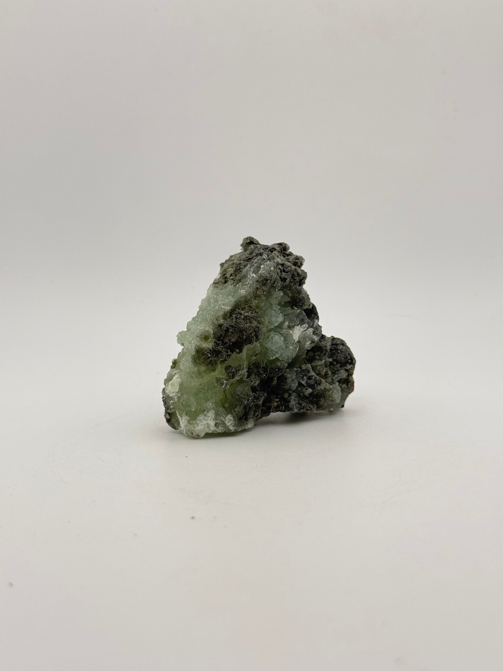 Raw Prehnite specimen with amazing green color.