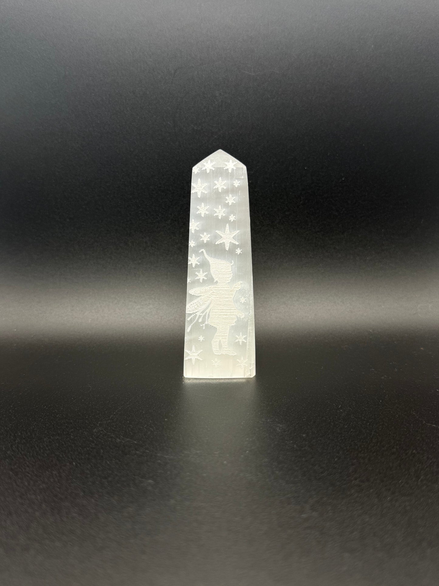 Selenite tower with engraved image of a fairy and stars.