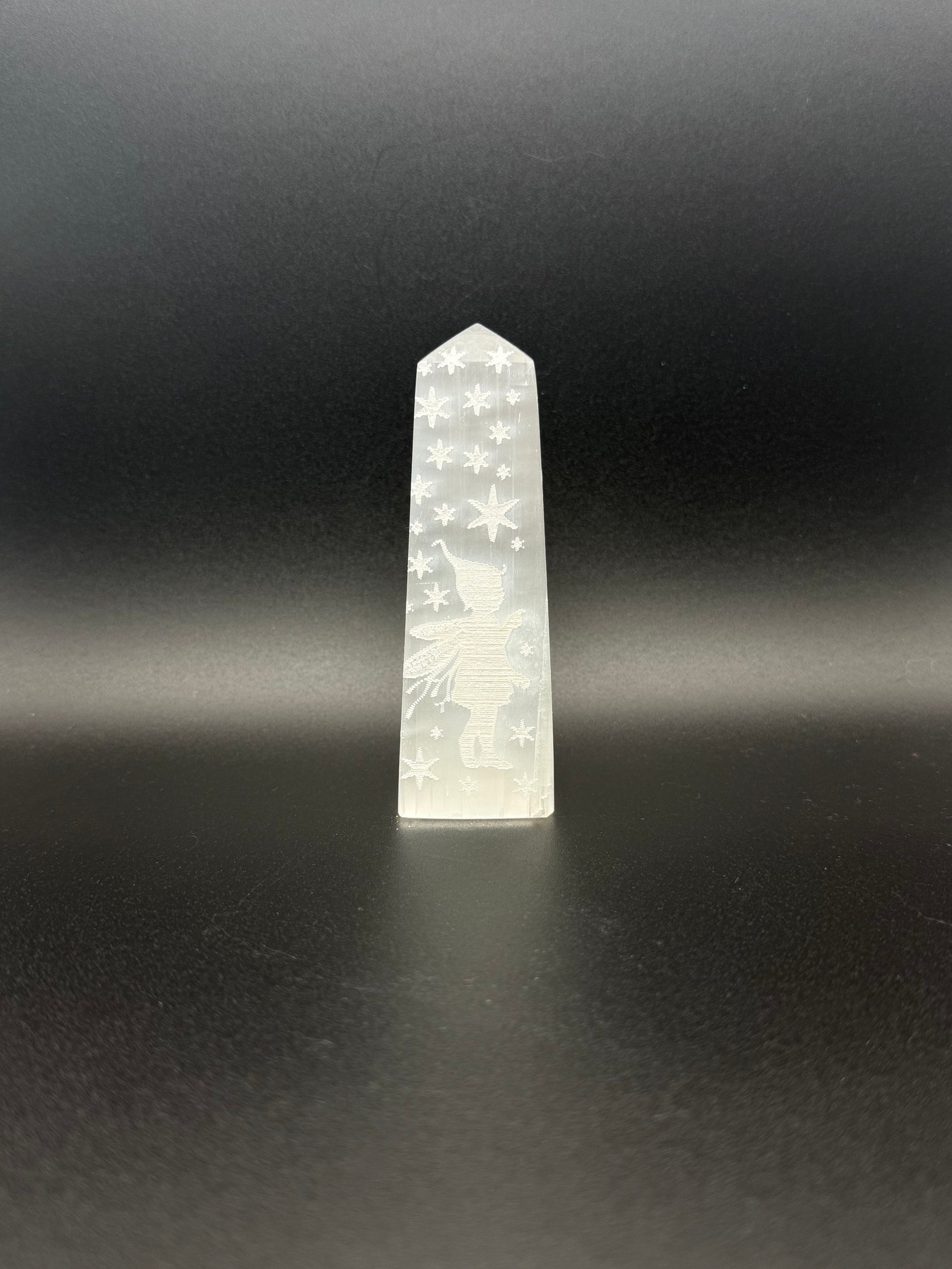 Selenite tower with engraved image of a fairy and stars.