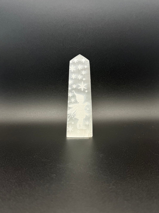 Selenite tower with engraved image of a fairy and stars.