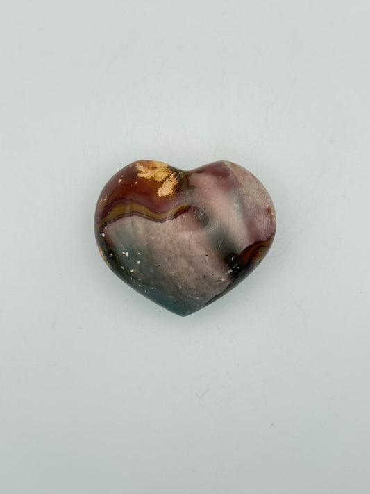 A polished polychrome jasper shaped into a heart.