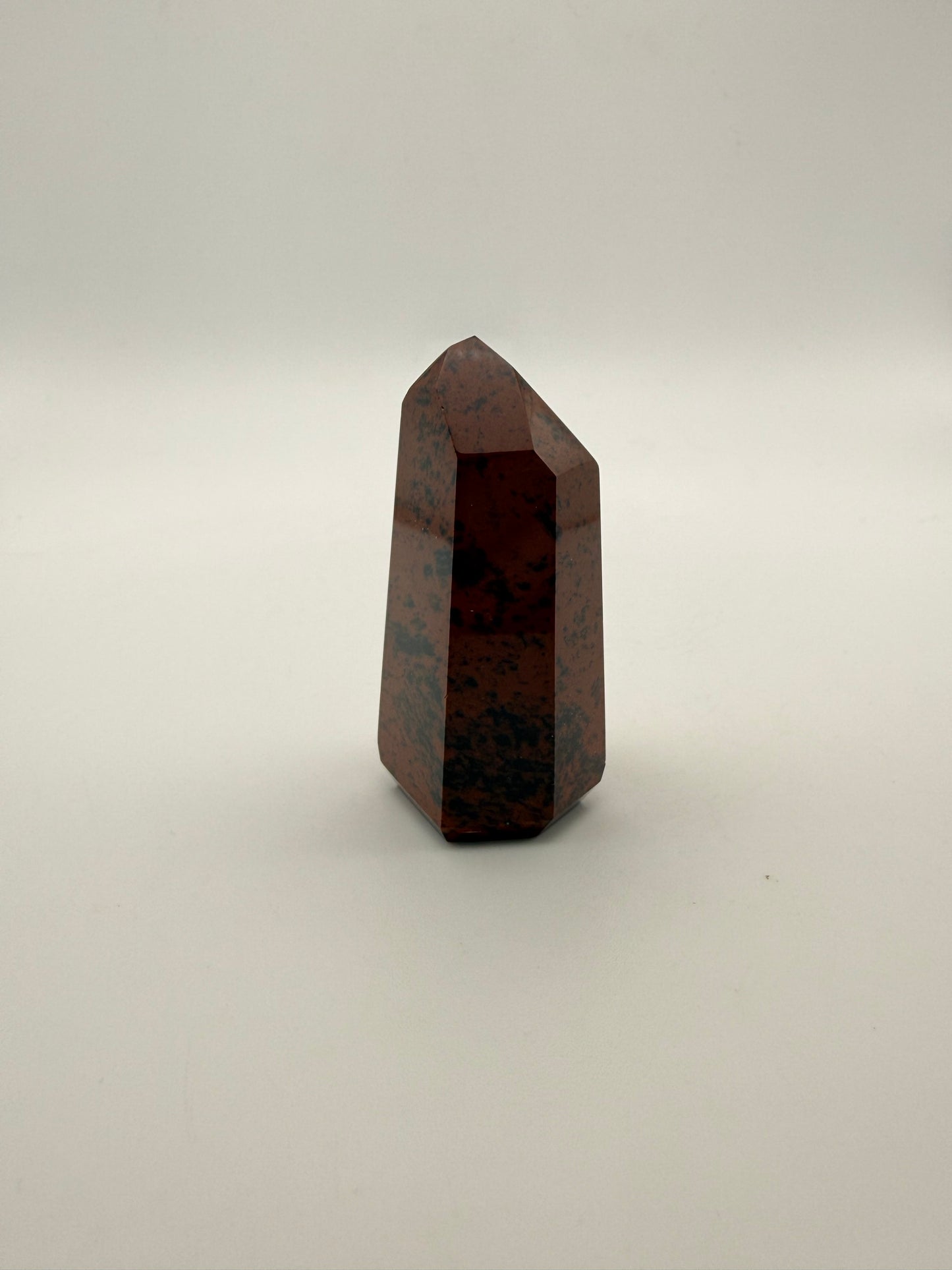 Polished mahogany obsidian tower with six sides.