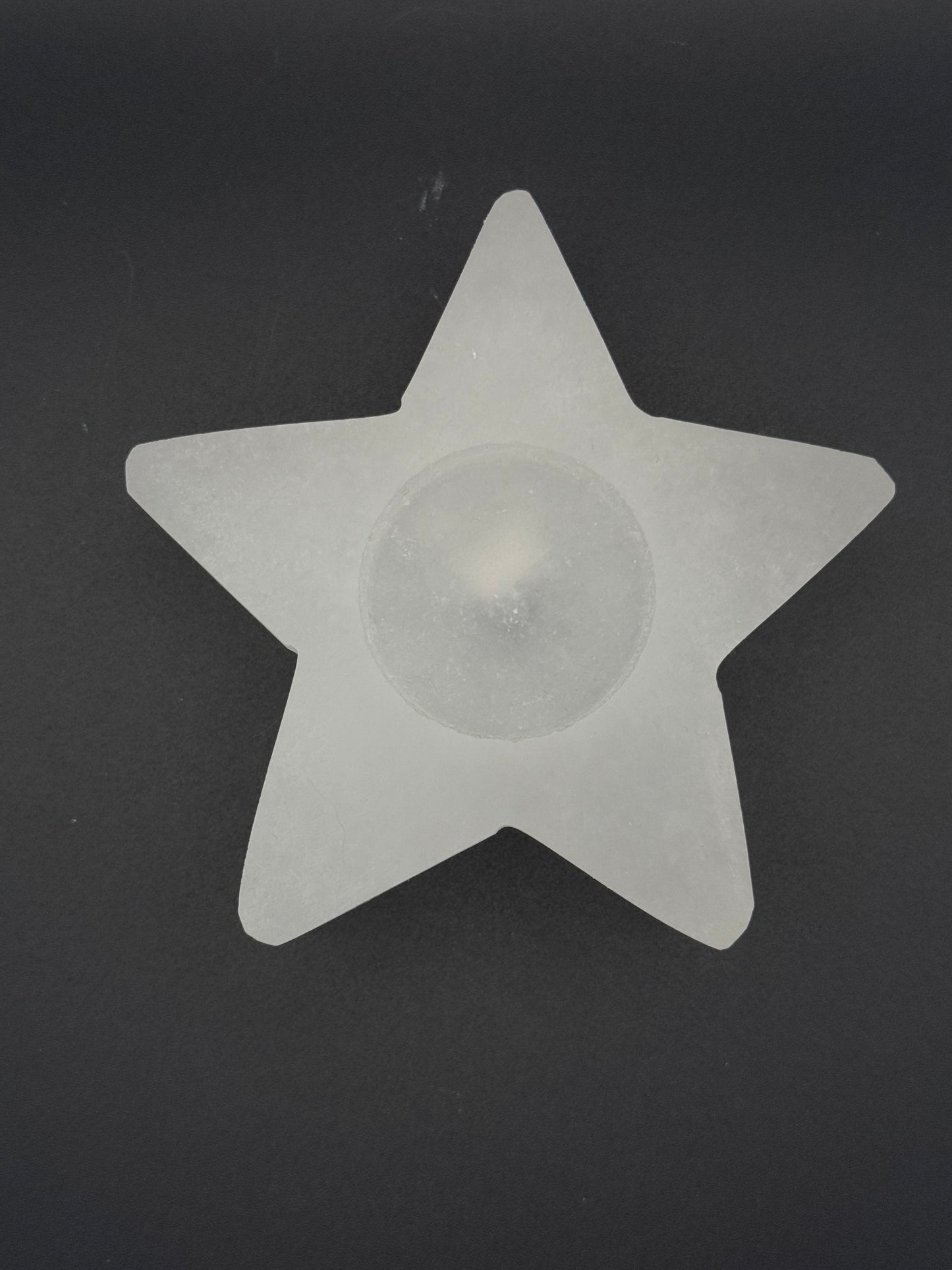 Star-shaped selenite candle holder.