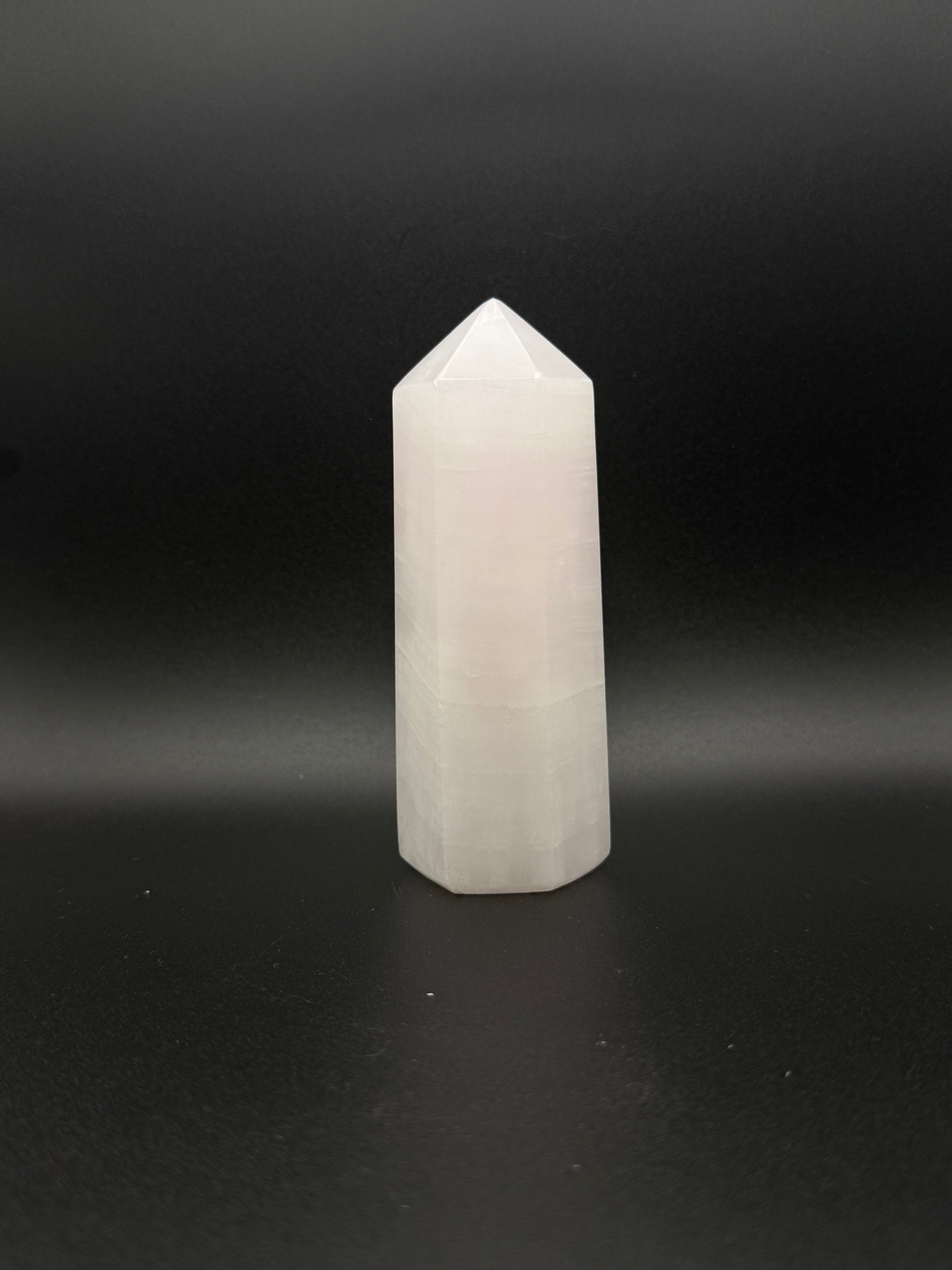 Polished pink calcite tower. Pink calcite glows under uv light.