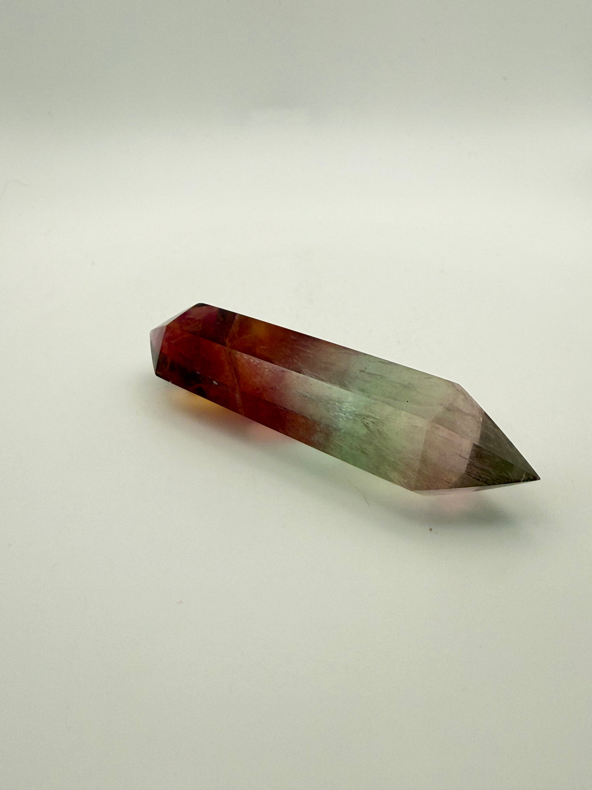 Rainbow Fluorite polished crystal in the shape of a double term.
