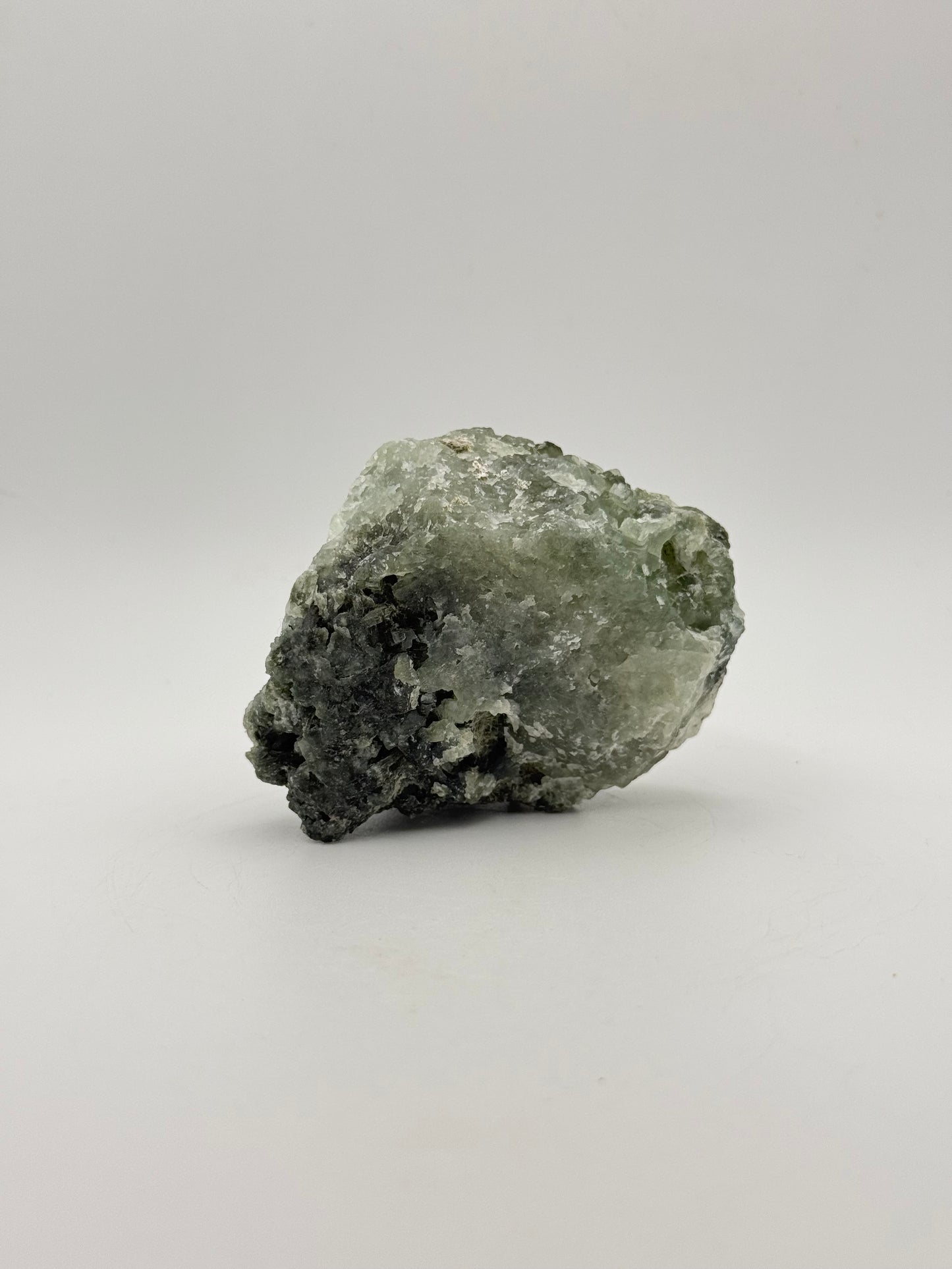 Raw Prehnite specimen with amazing green color.