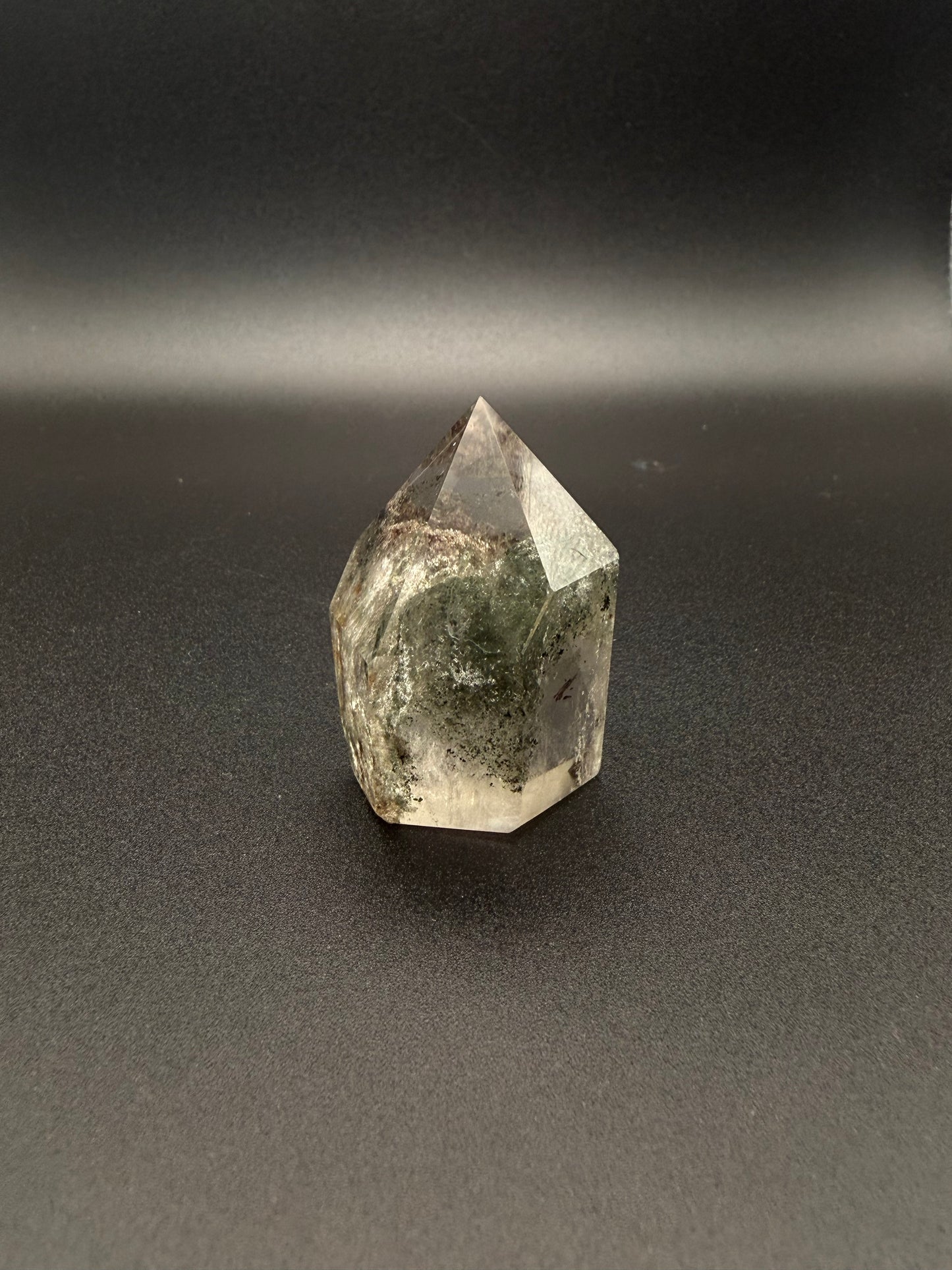 Polished garden quartz crystal tower with six sides.