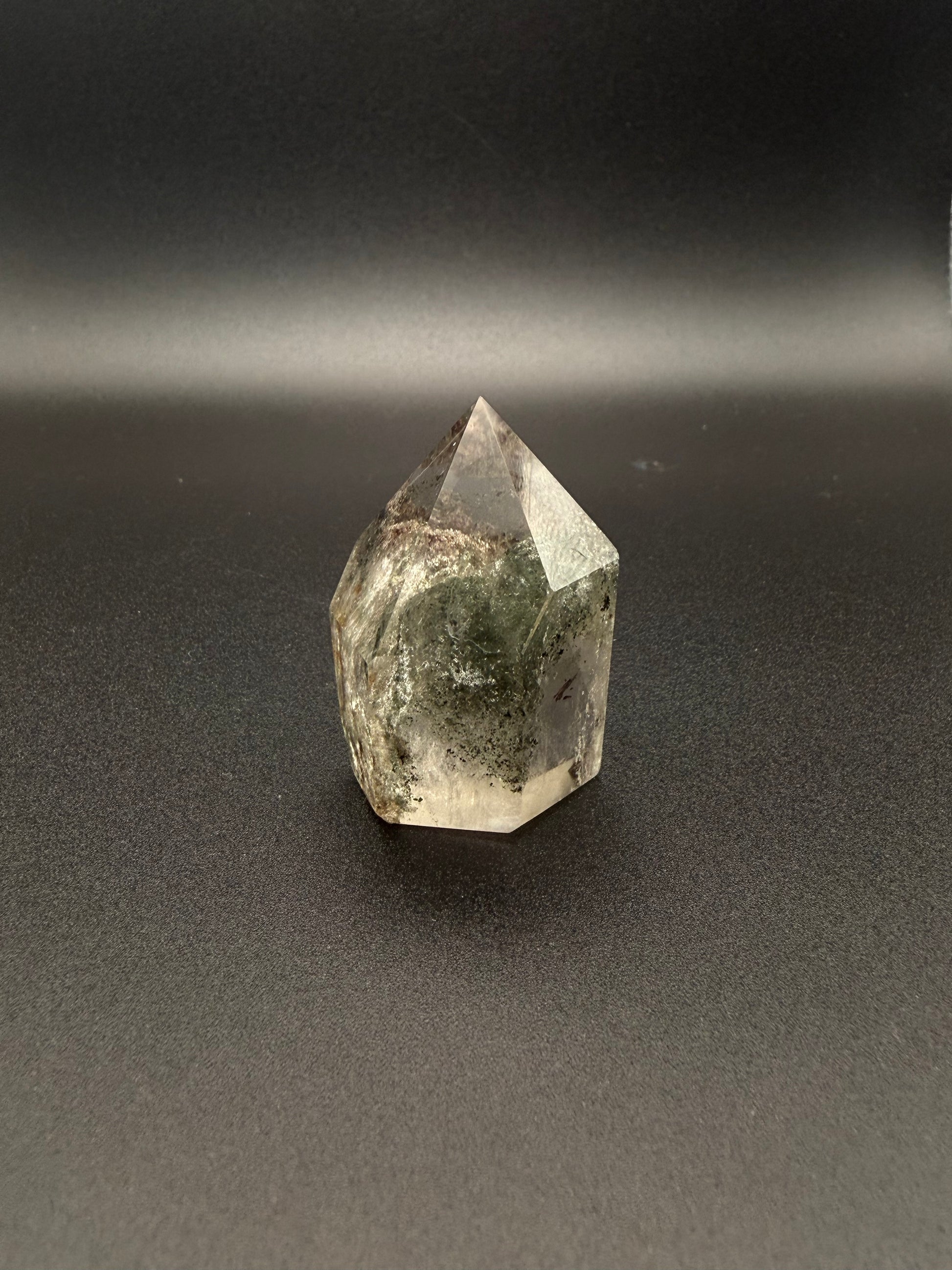 Polished garden quartz crystal tower with six sides.