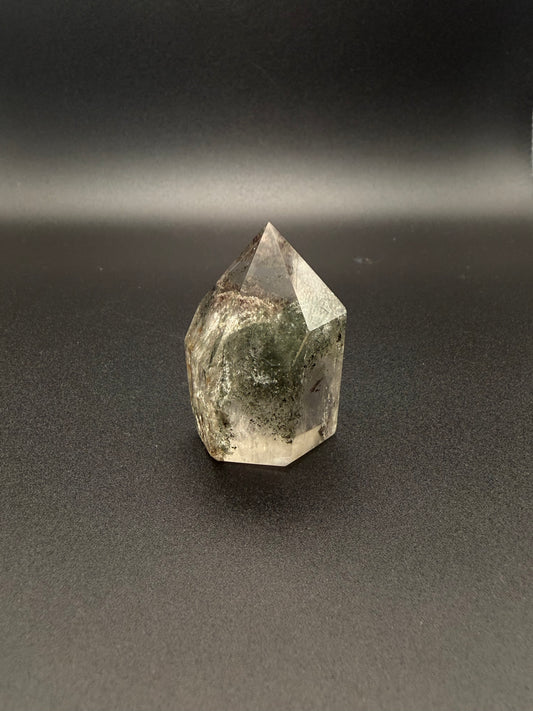 Polished garden quartz crystal tower with six sides.