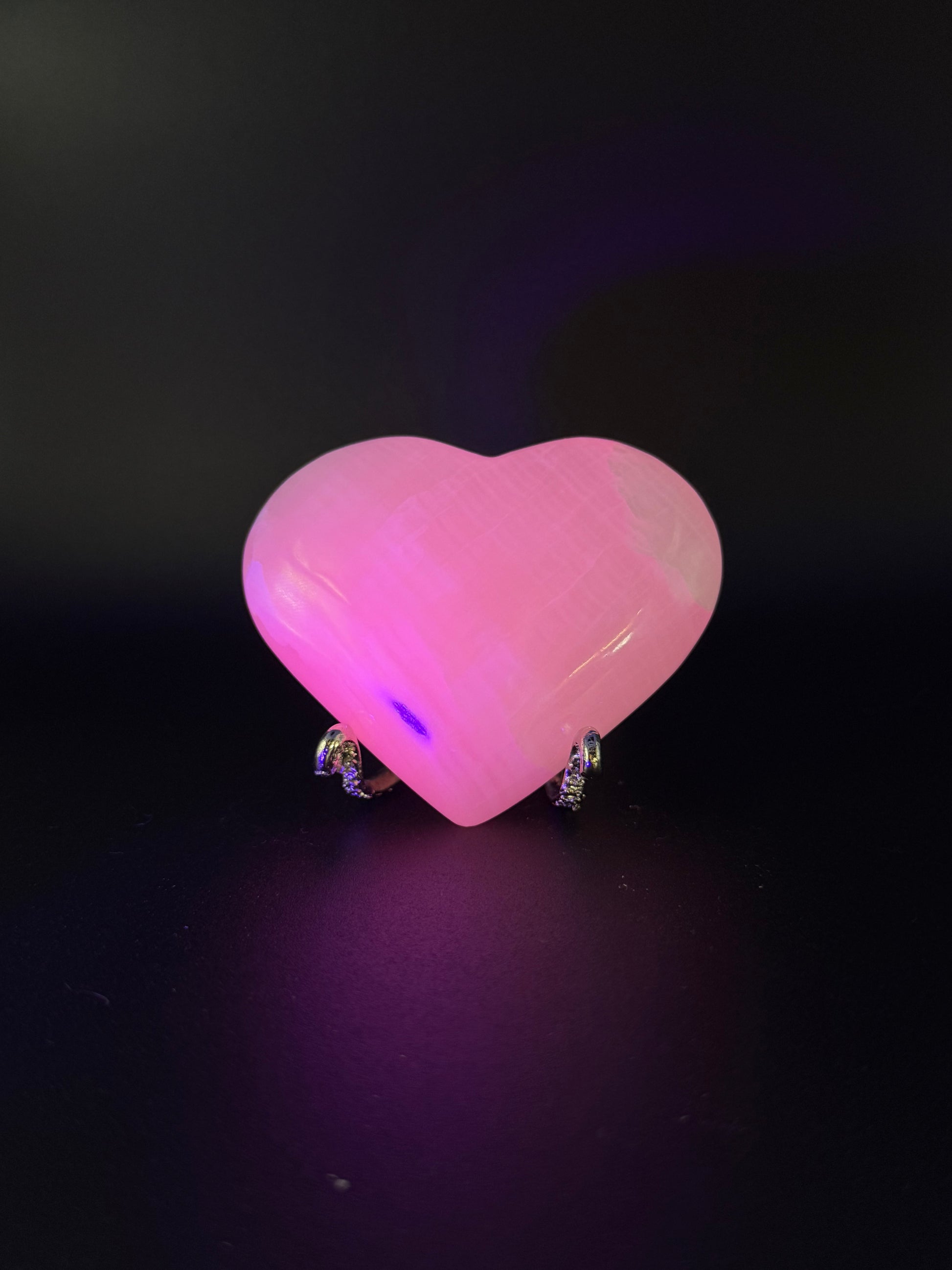 Polished Pink Calcite heart. Pink calcite is uv reactive.