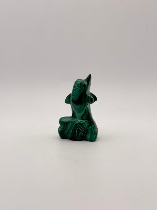 Polished malachite dolphin carving.