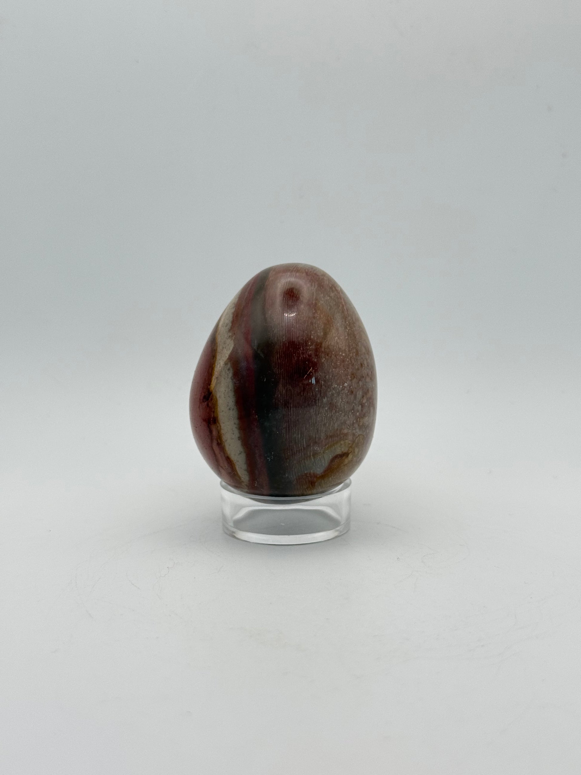 Polished polychrome jasper shaped into an egg.