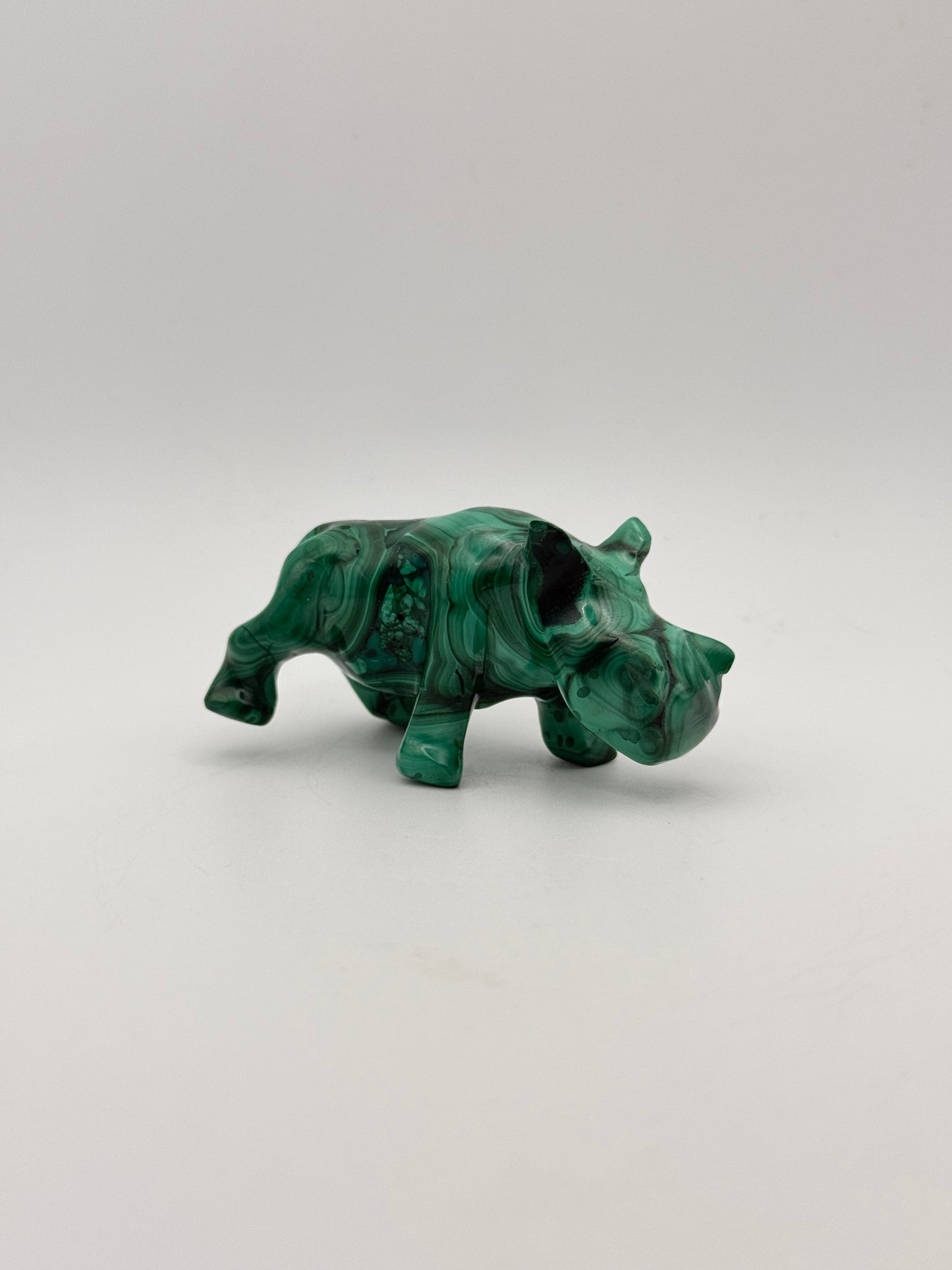 Vibrant green malachite carving of a rhino.