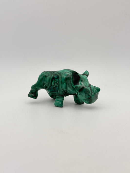 Vibrant green malachite carving of a rhino.