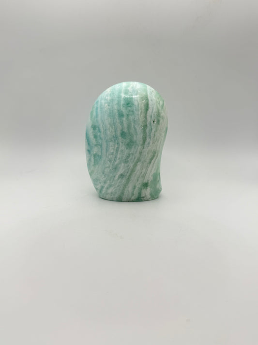 Caribbean calcite polished crystal free form in the shape of a dome.
