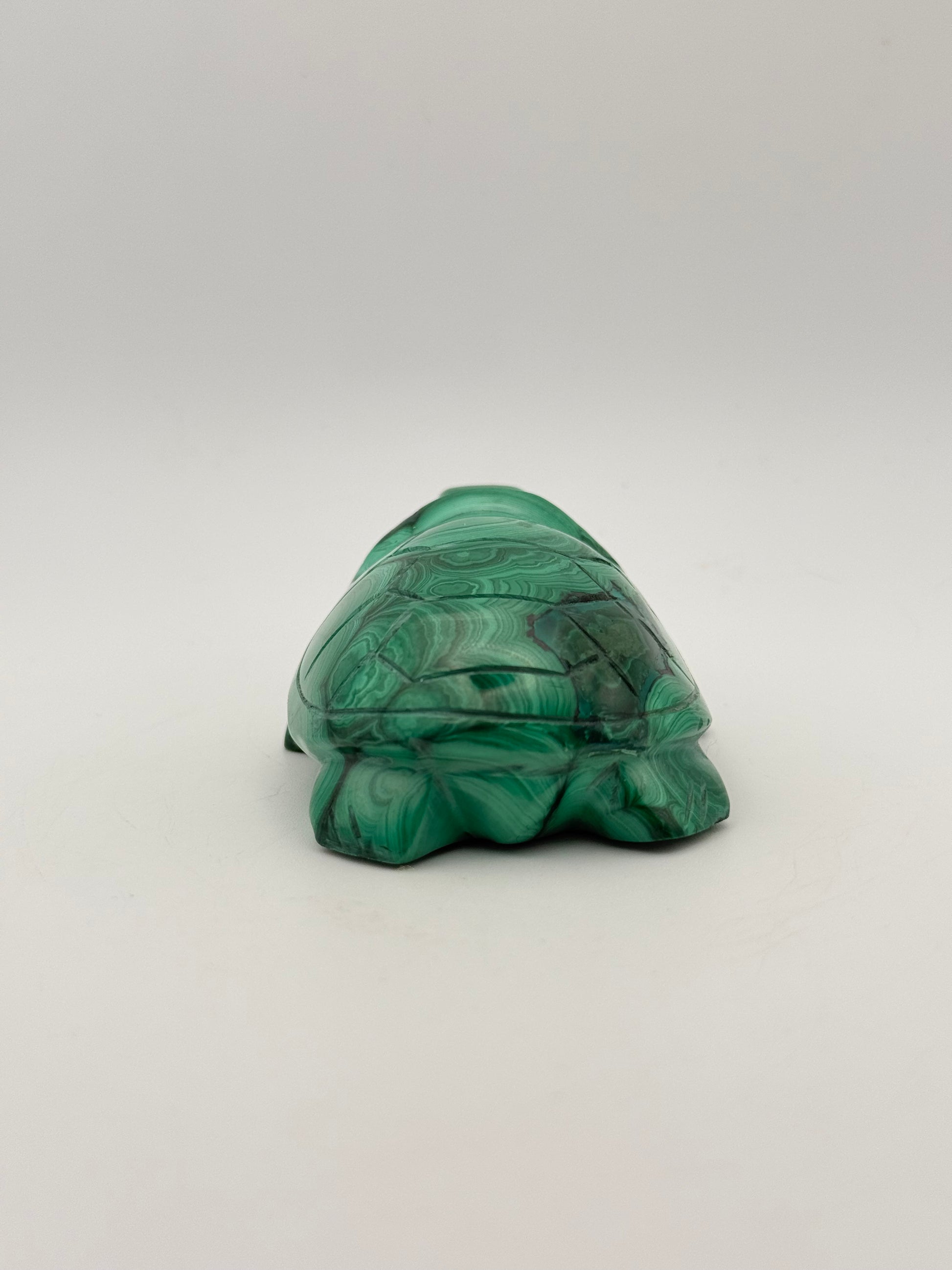 Vibrant green malachite stone carving of a turtle.
