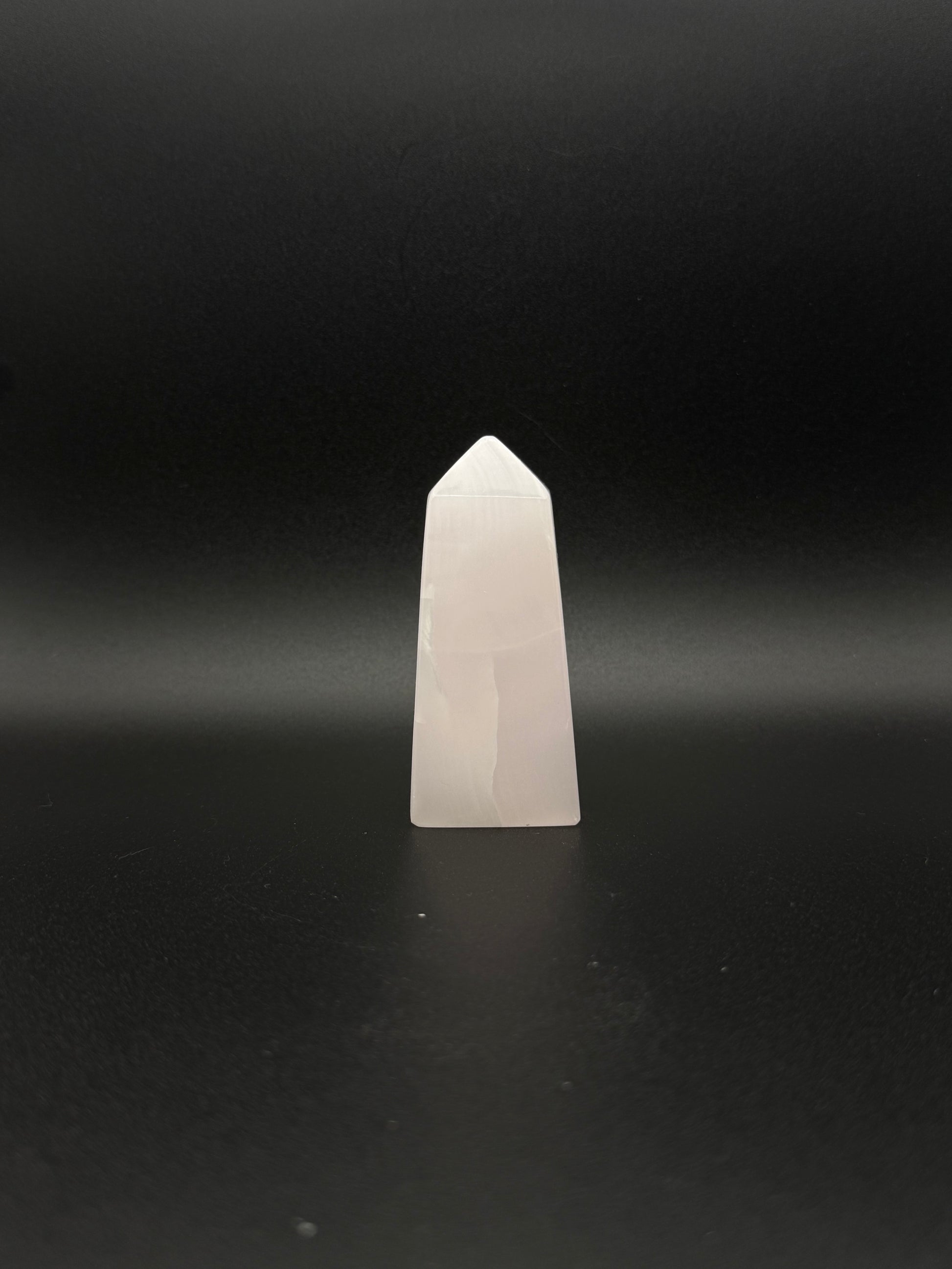 Polished pink calcite tower. Pink calcite glows under uv light.