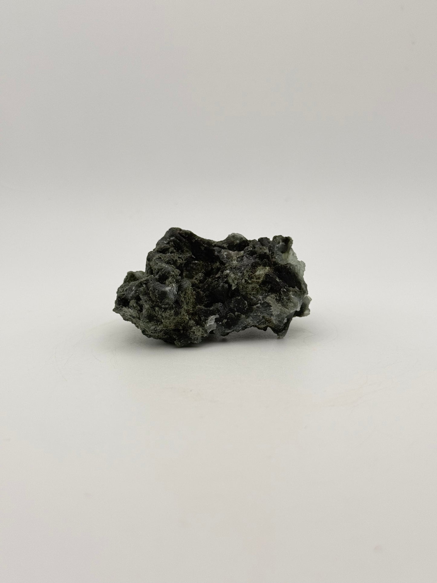 Raw Prehnite specimen with amazing green color.