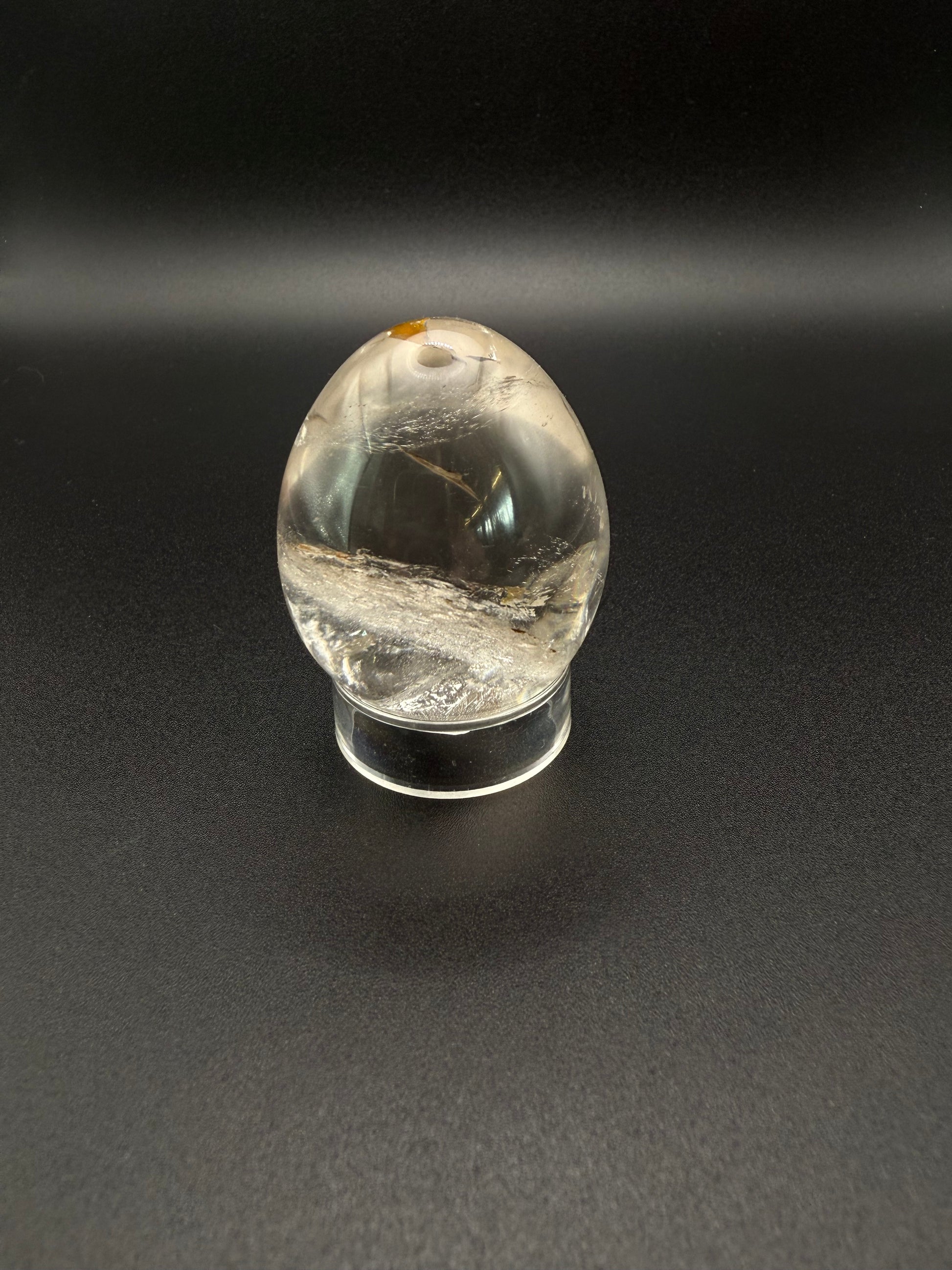 Clear quartz polished crystal thats egg shaped.