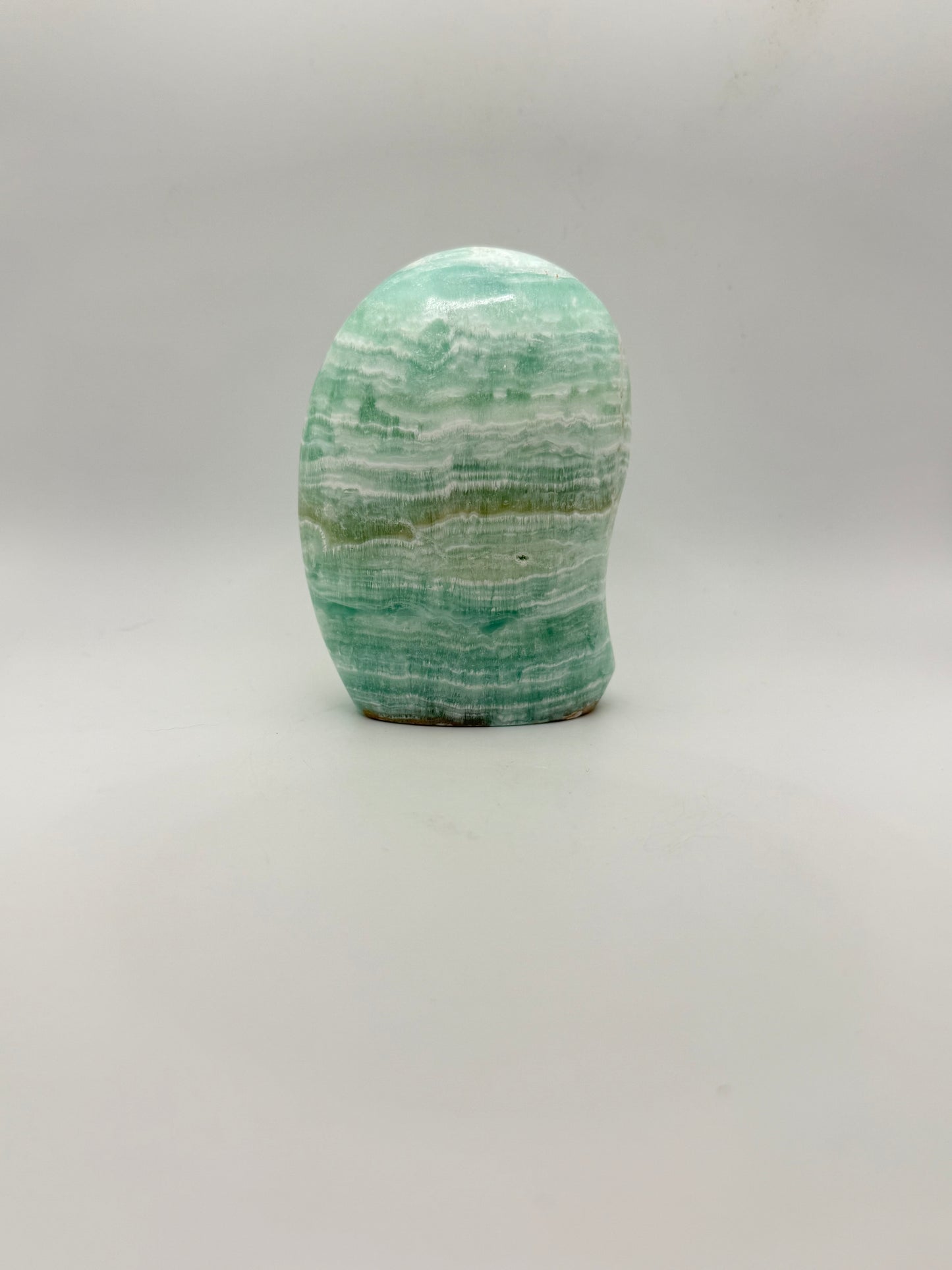 Caribbean calcite polished crystal free form in the shape of a dome.