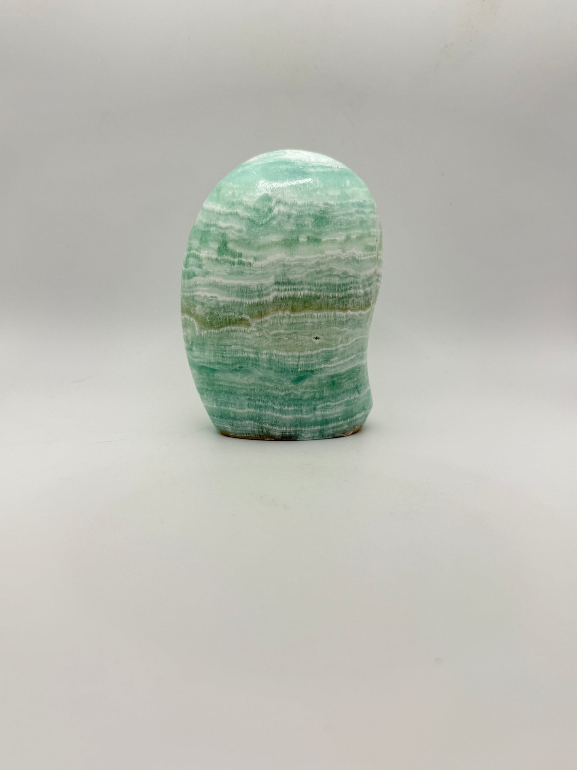Caribbean calcite polished crystal free form in the shape of a dome.