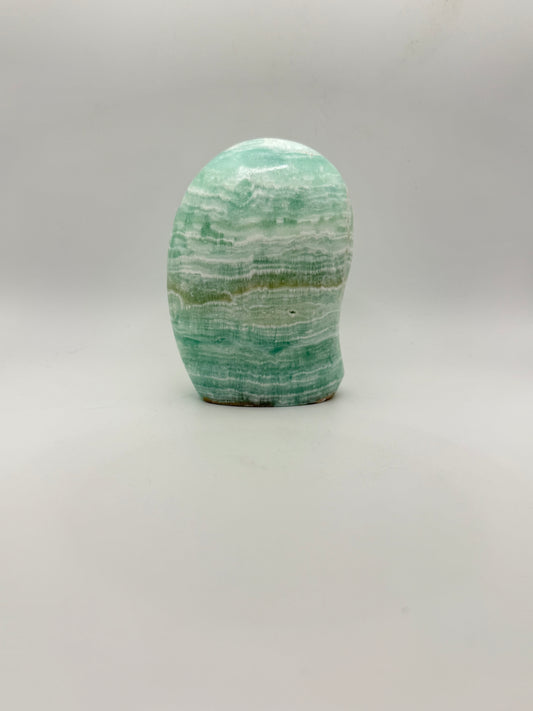 Caribbean calcite polished crystal free form in the shape of a dome.
