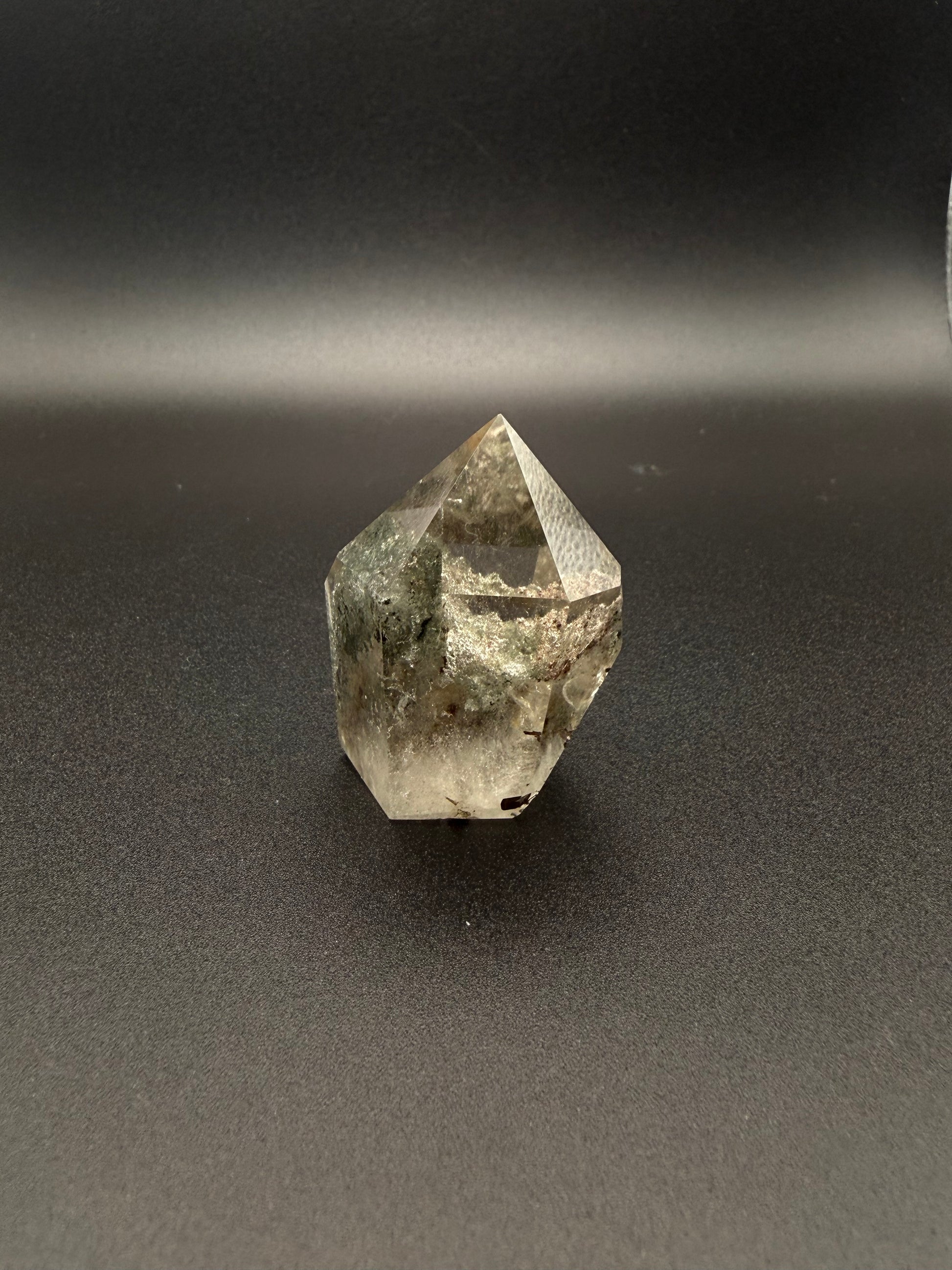Polished garden quartz crystal tower with six sides.