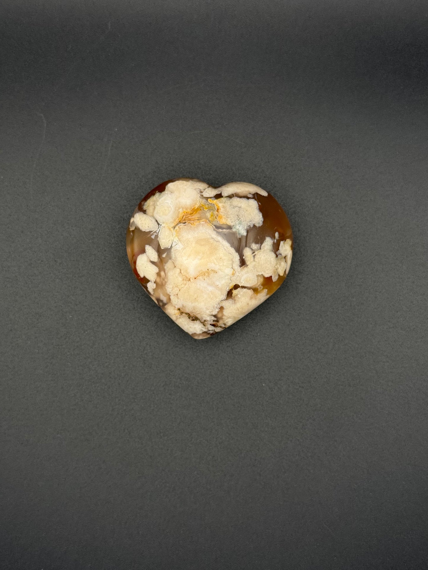 Flower Agate polished crystal in the shape of a heart.