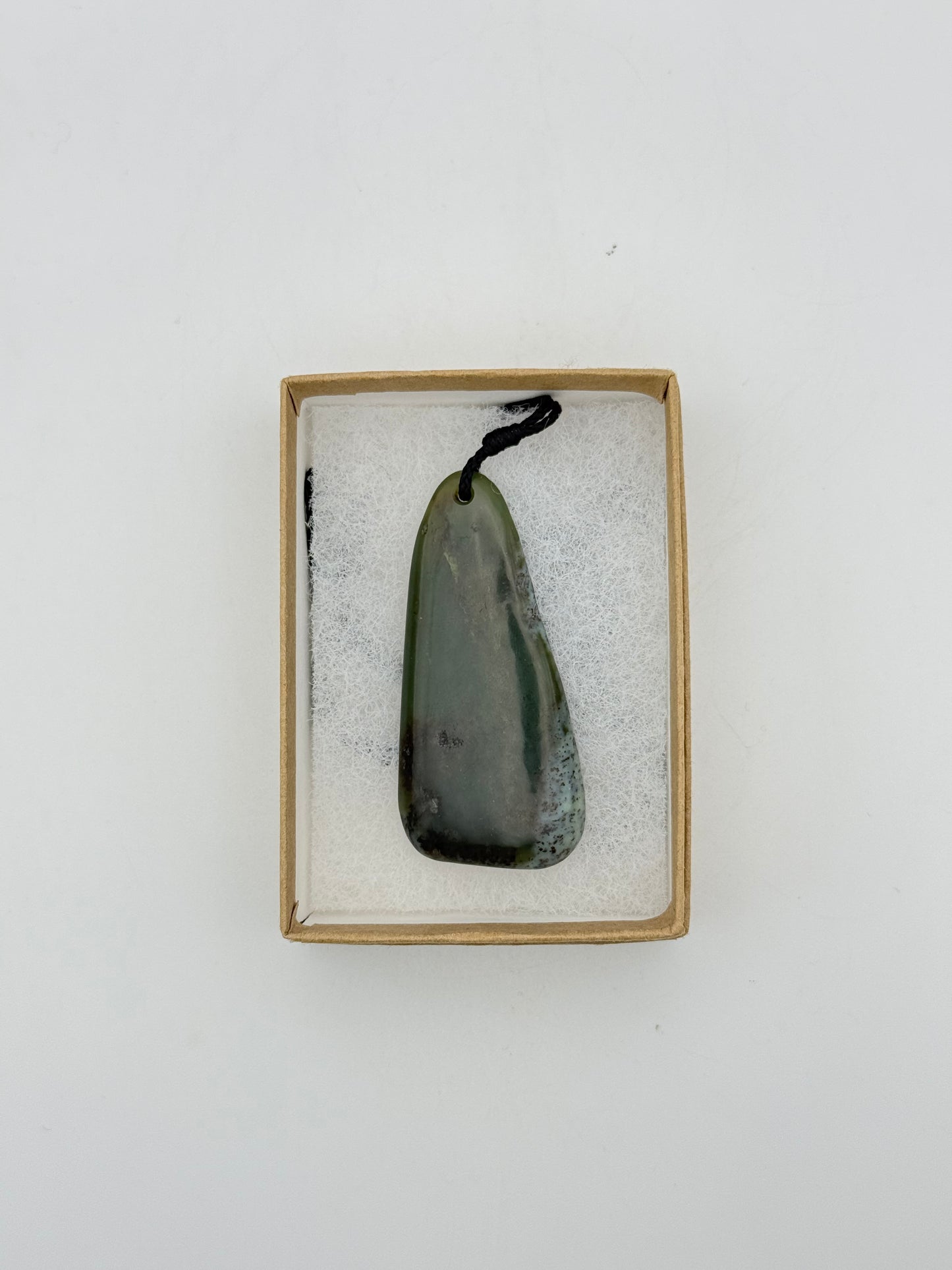 Green Jade pendant with string necklace.