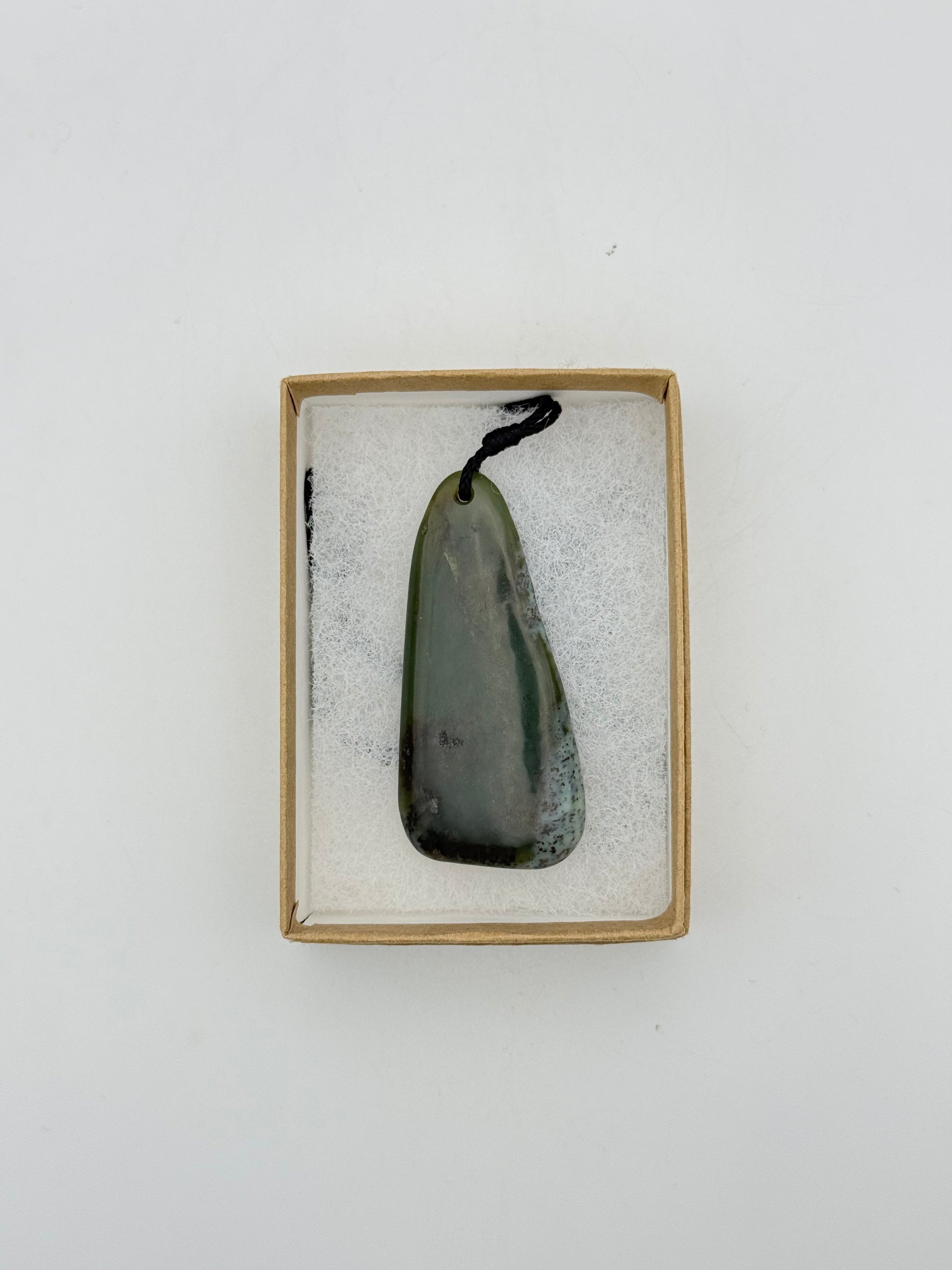 Green Jade pendant with string necklace.