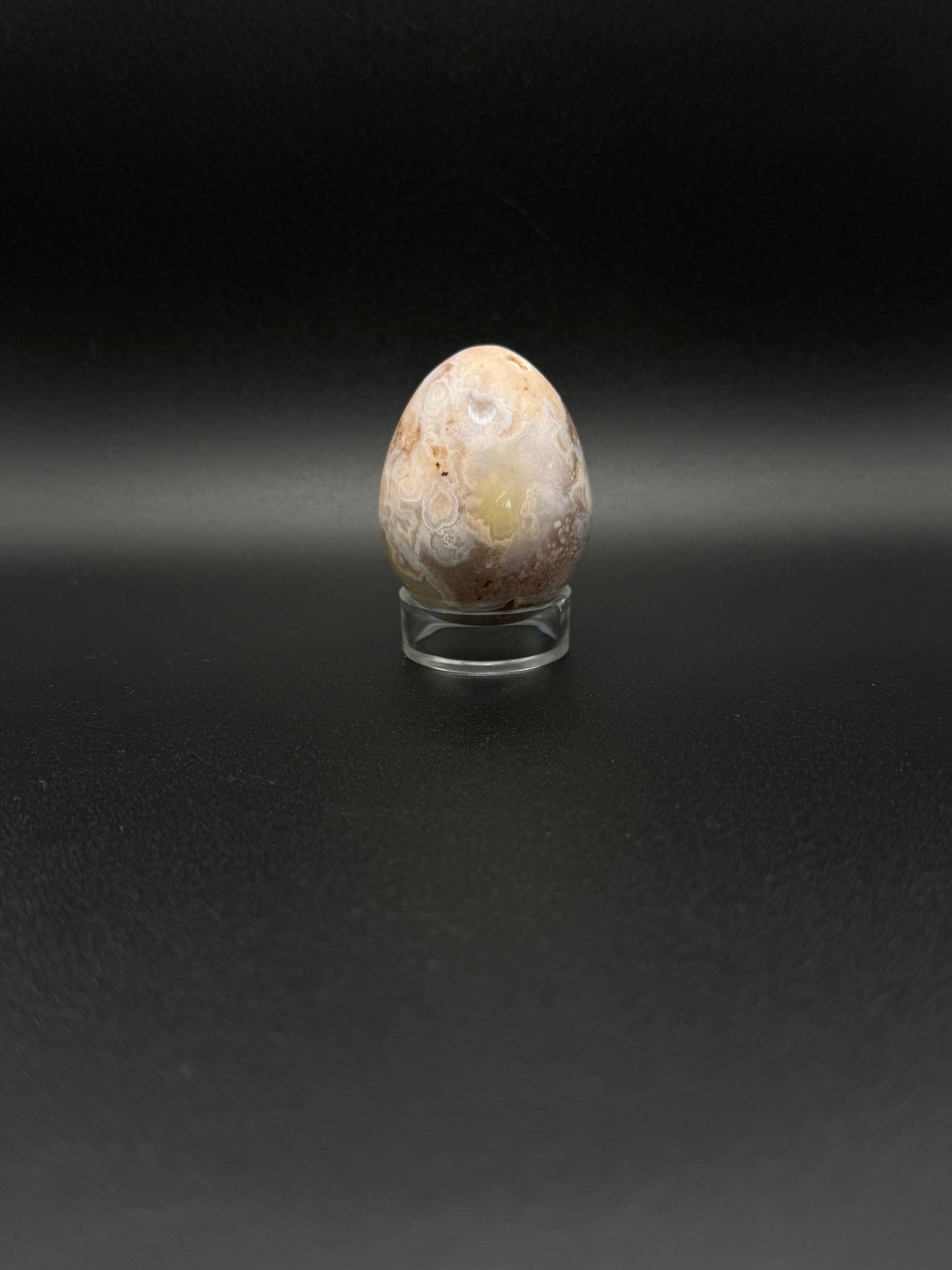 Polished flower agate crystal in the shape of an egg.
