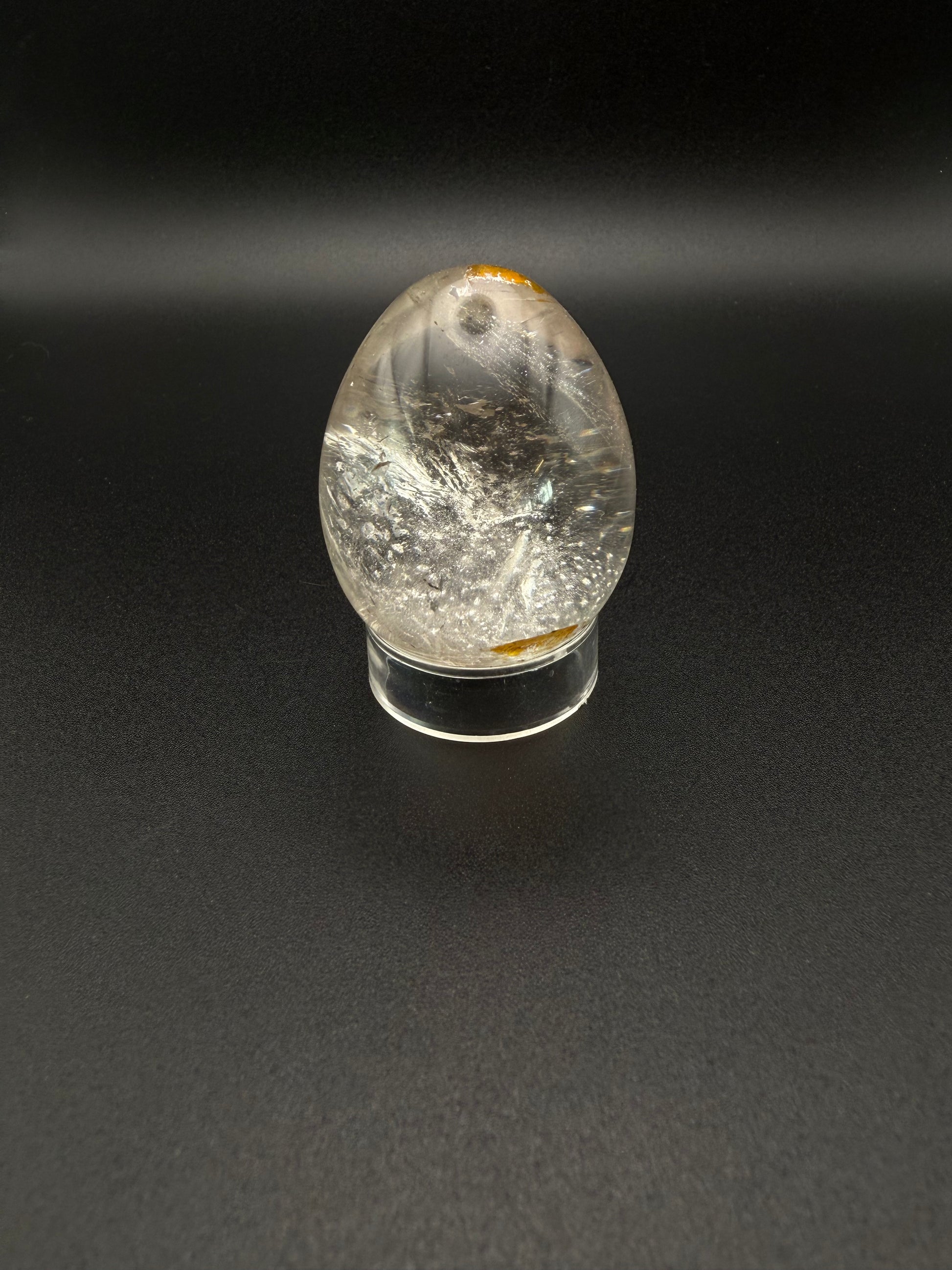 Clear quartz polished crystal thats egg shaped.