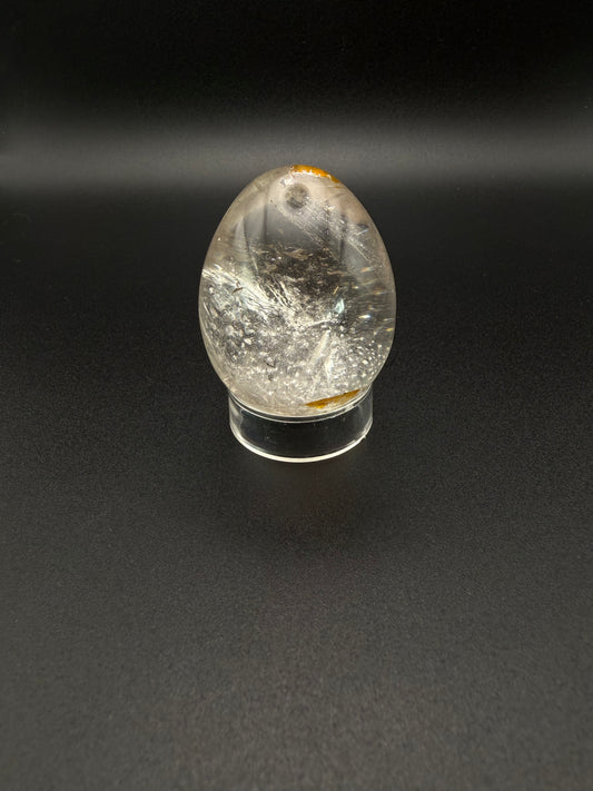 Clear quartz polished crystal thats egg shaped.