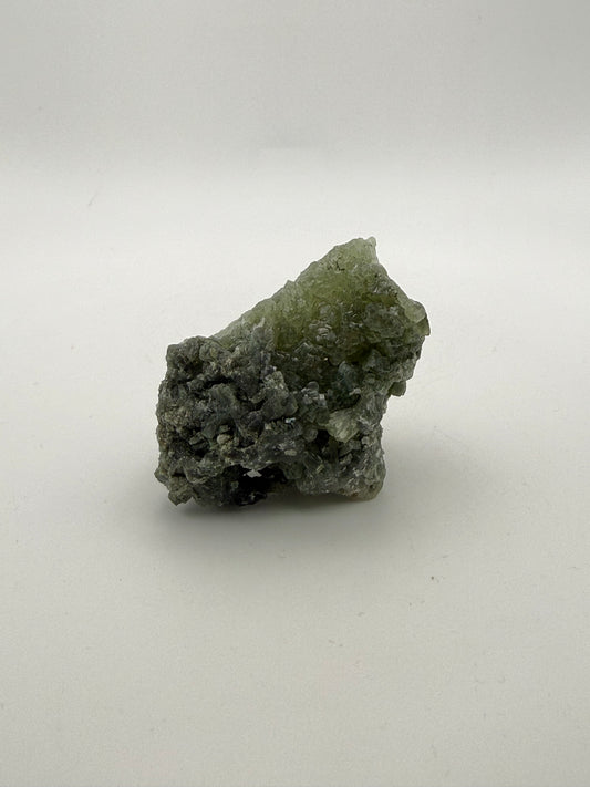 Raw prehnite specimen with good green coloring.