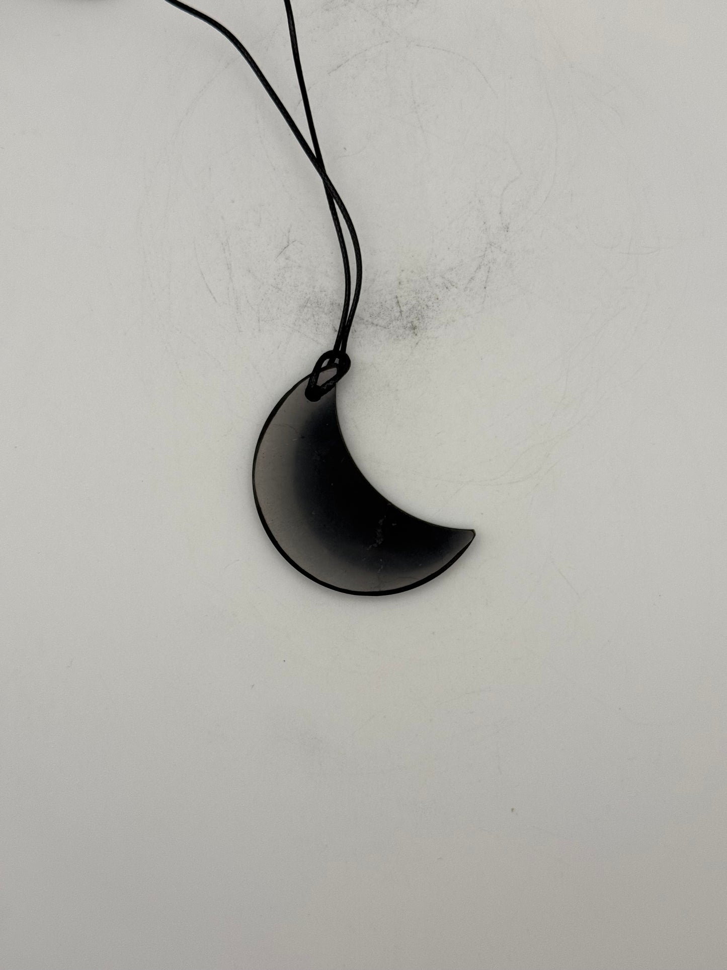 Shungite half moon pendant.