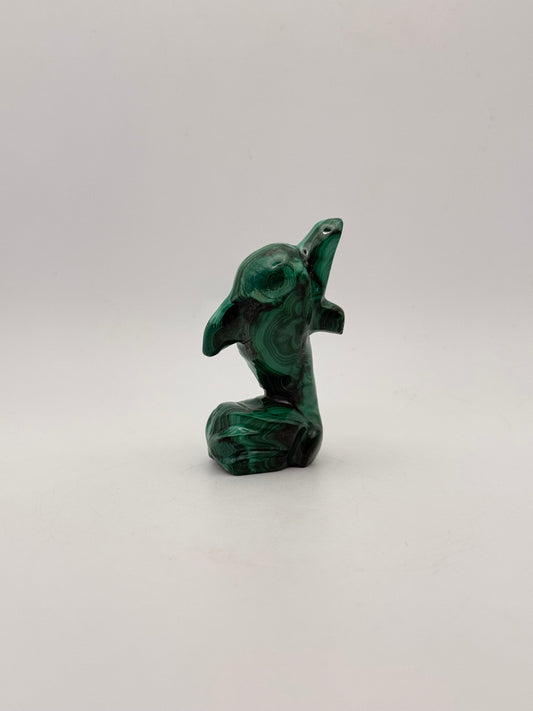 Polished malachite dolphin carving.