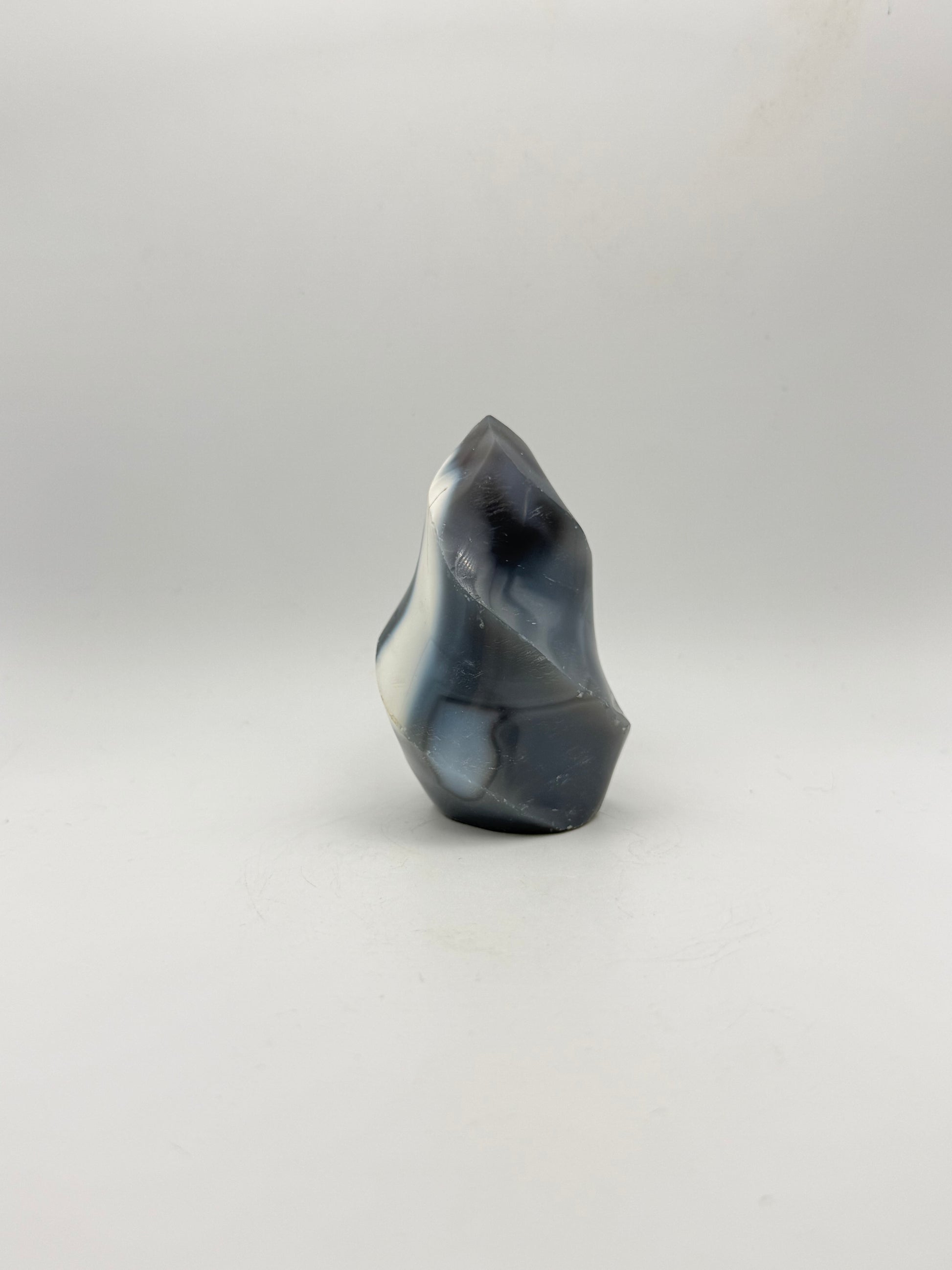 Polished orca agate in the shape of a flame.