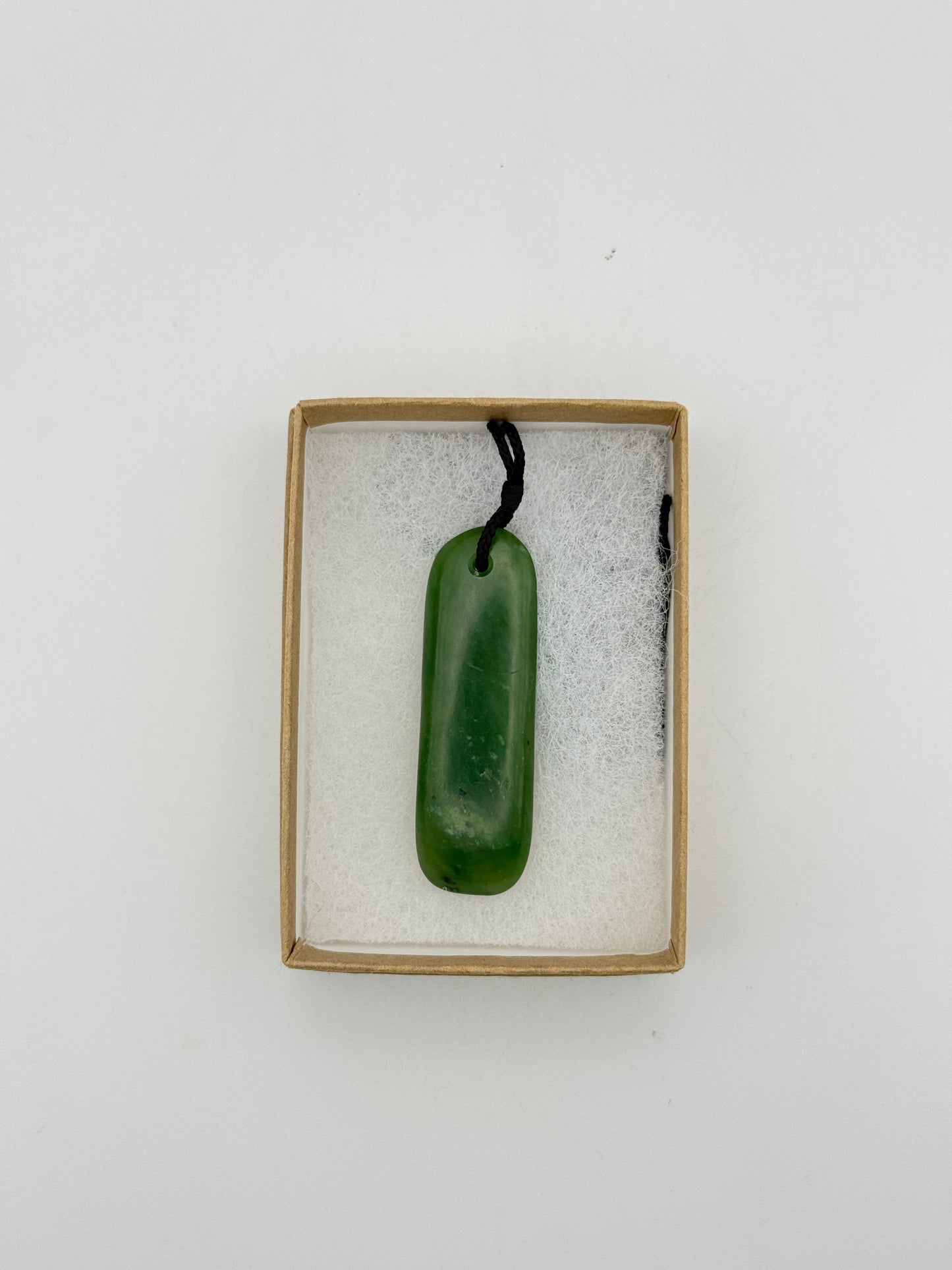 Green Jade pendant with string necklace.