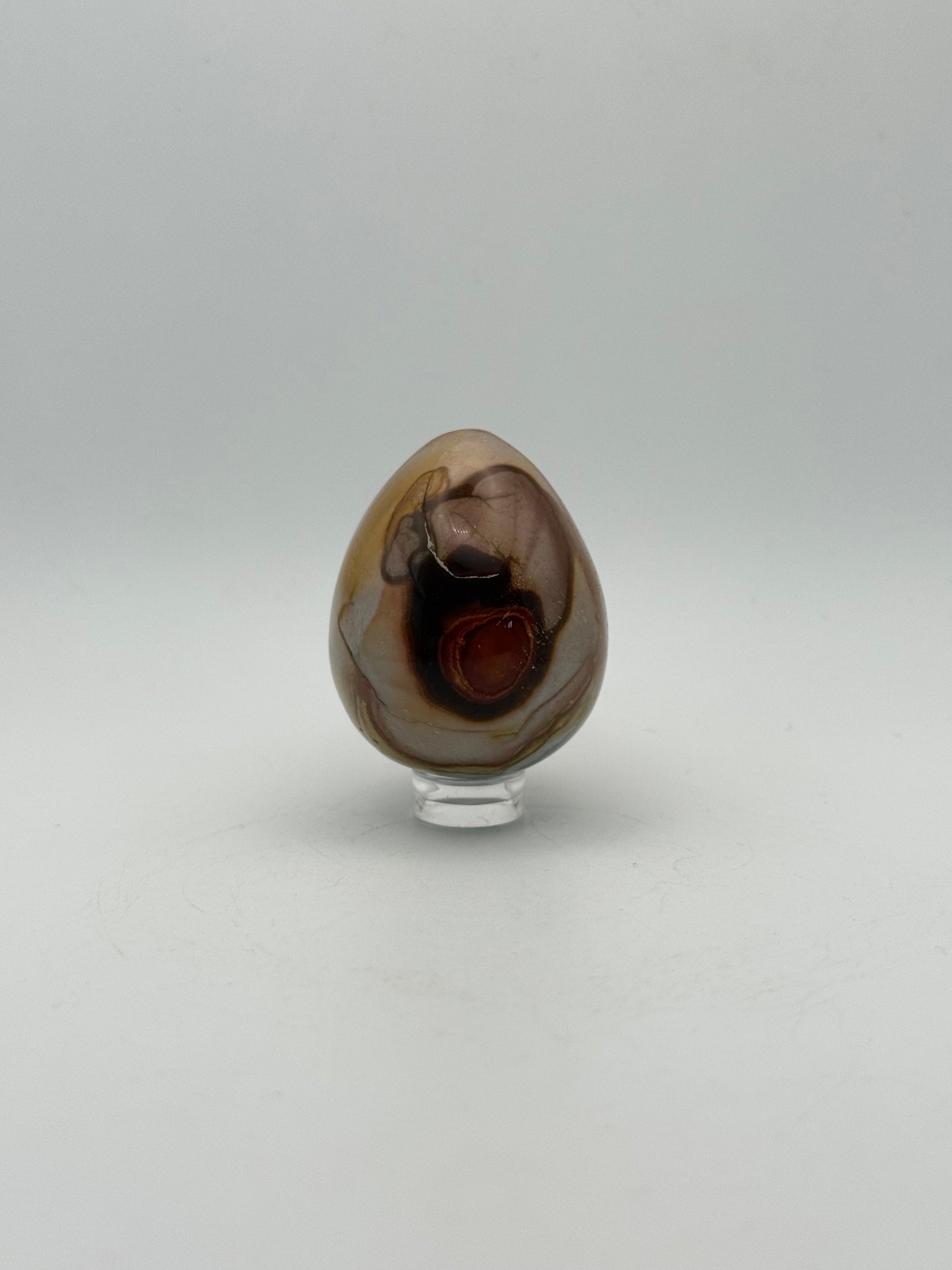 Polished polychrome jasper shaped into an egg.