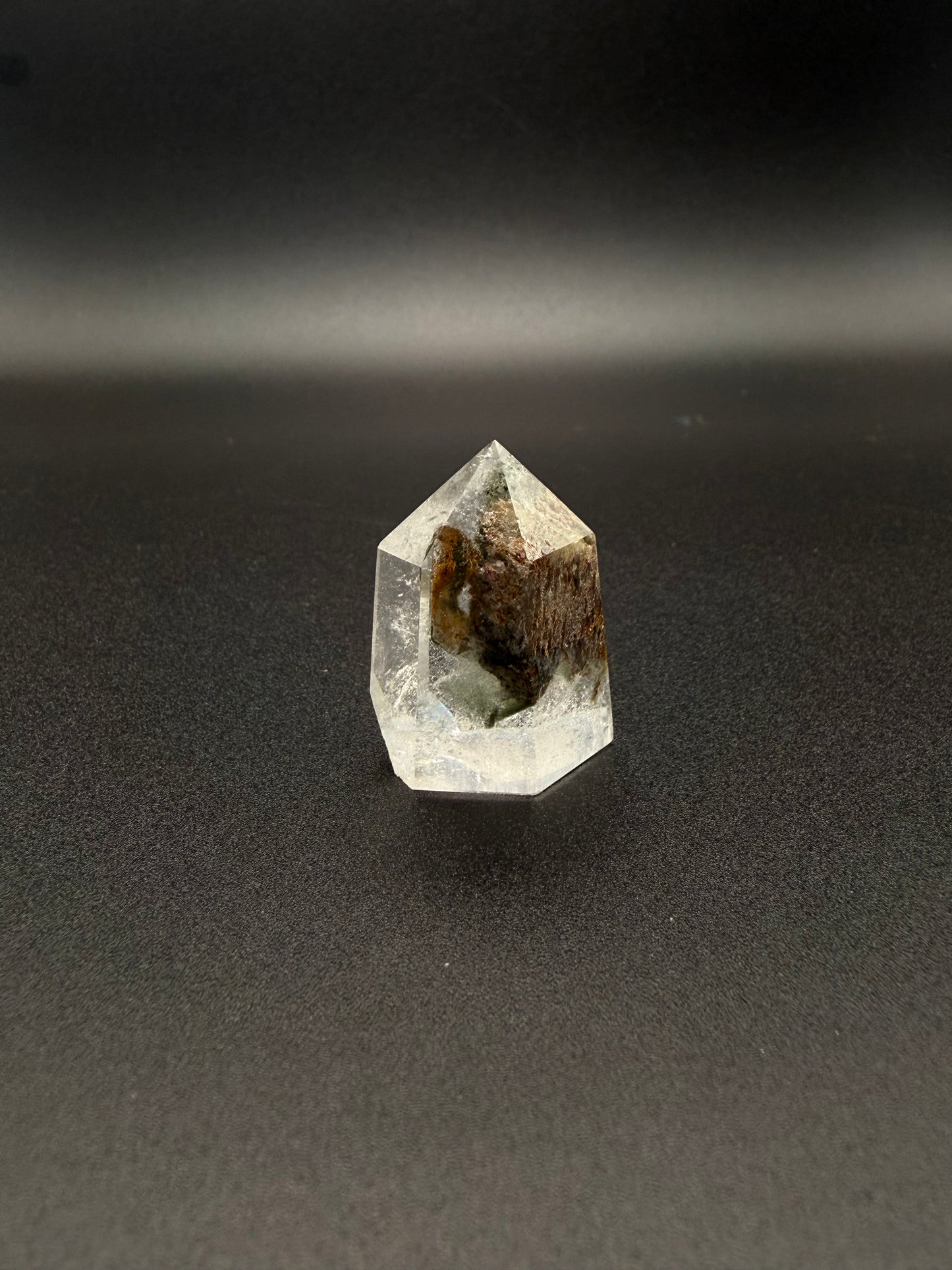 Polished garden quartz crystal tower with six sides.