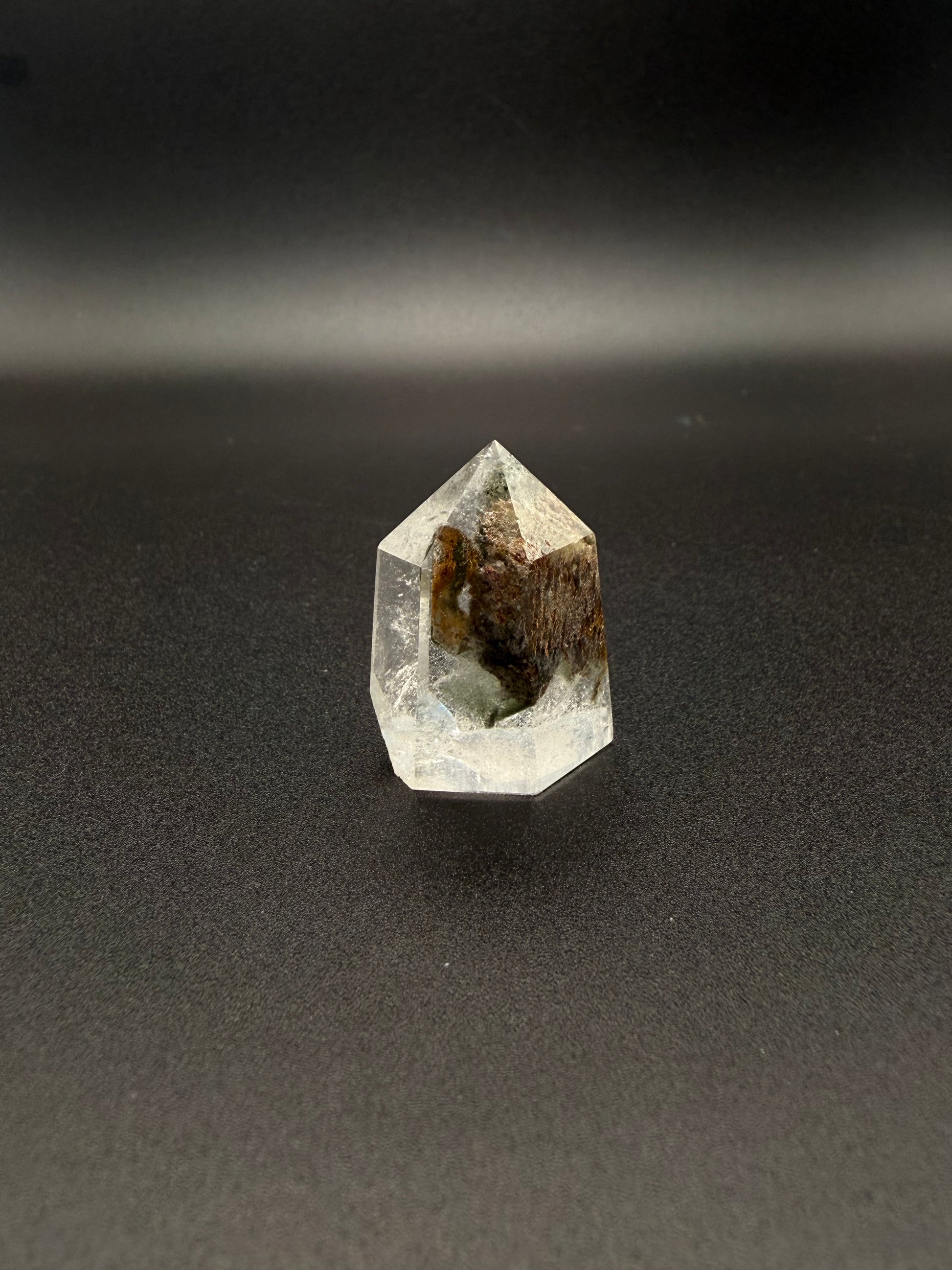 Polished garden quartz crystal tower with six sides.