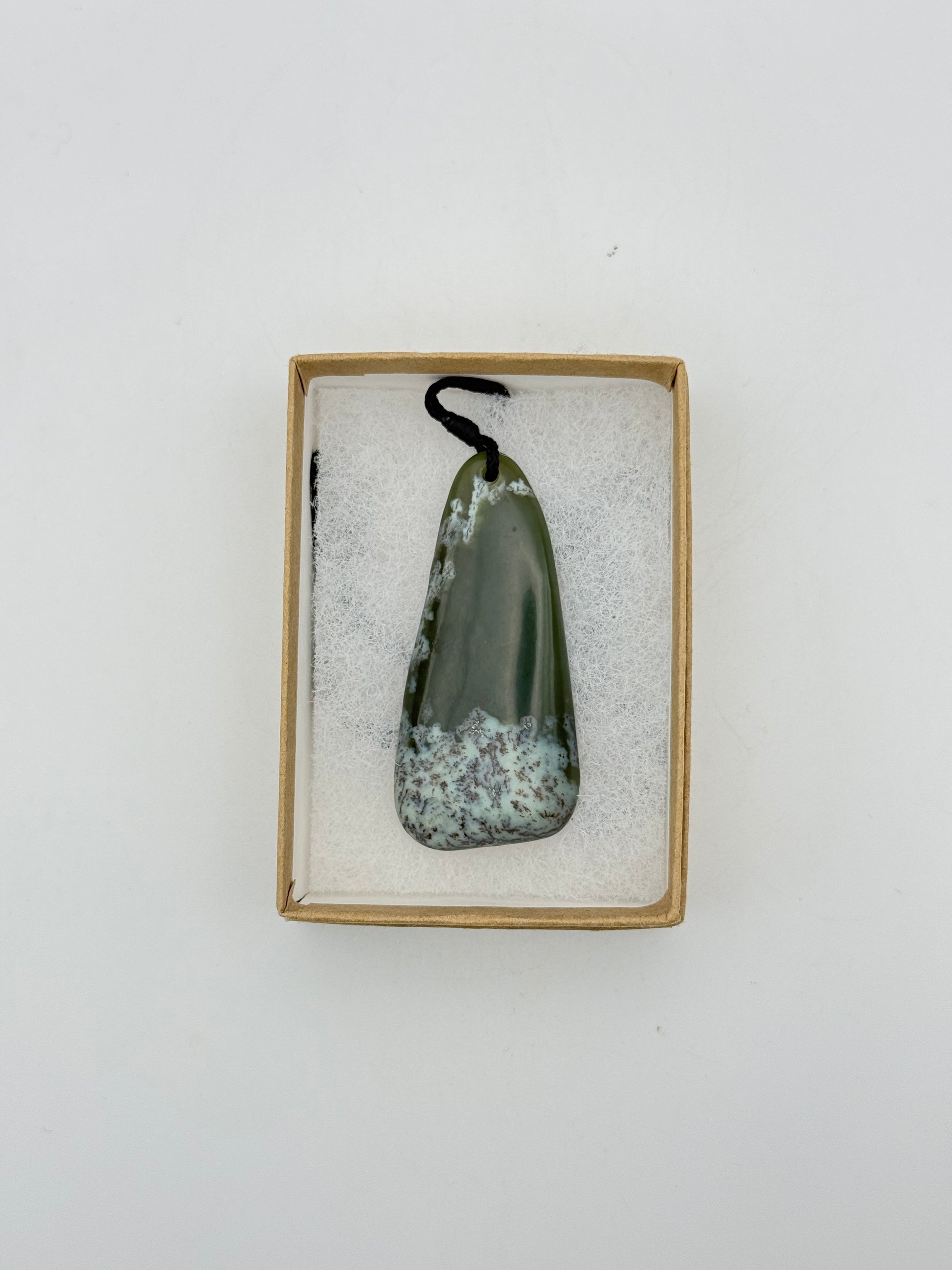 Green Jade pendant with string necklace.