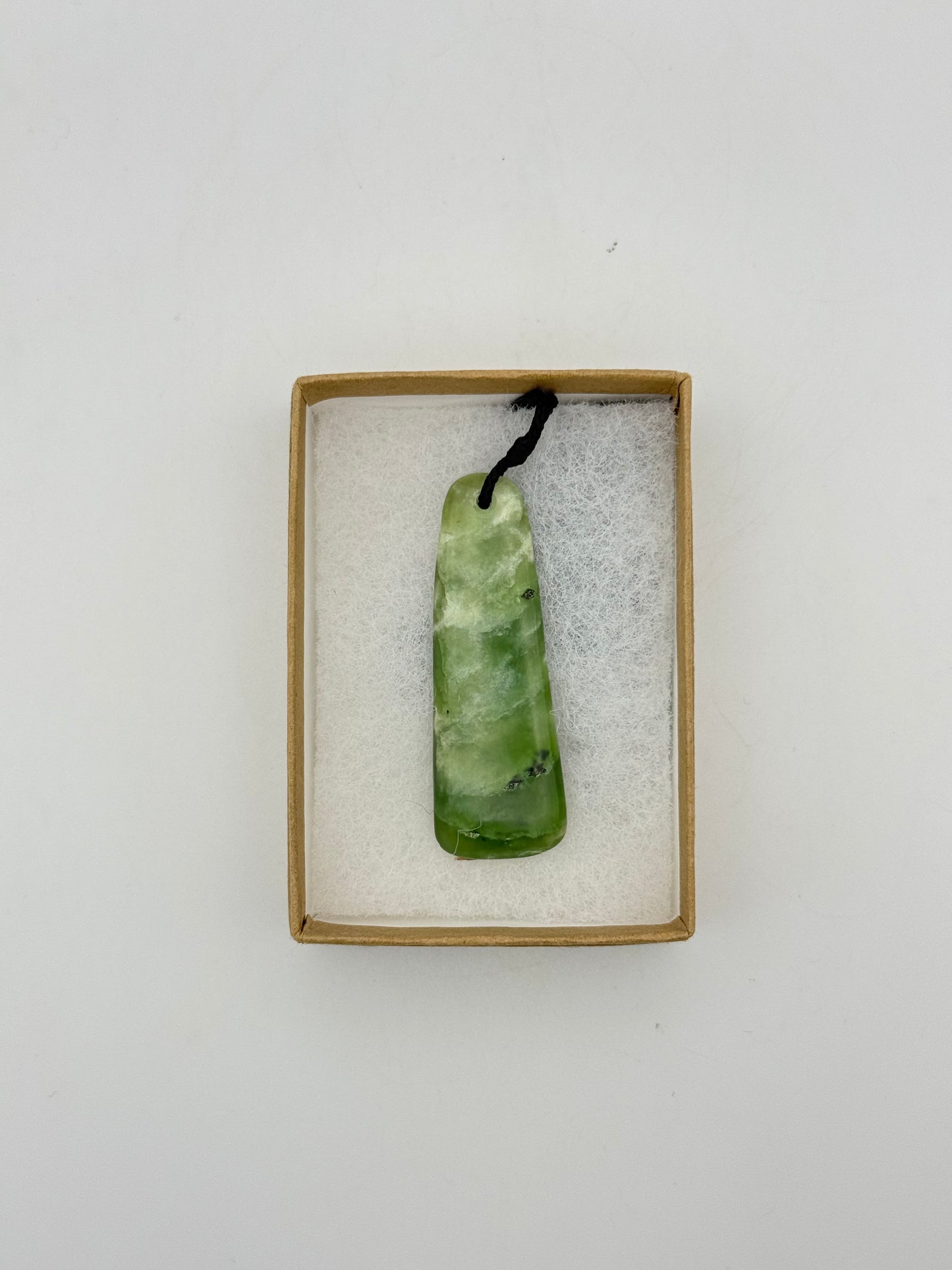 Green Jade pendant with string necklace.